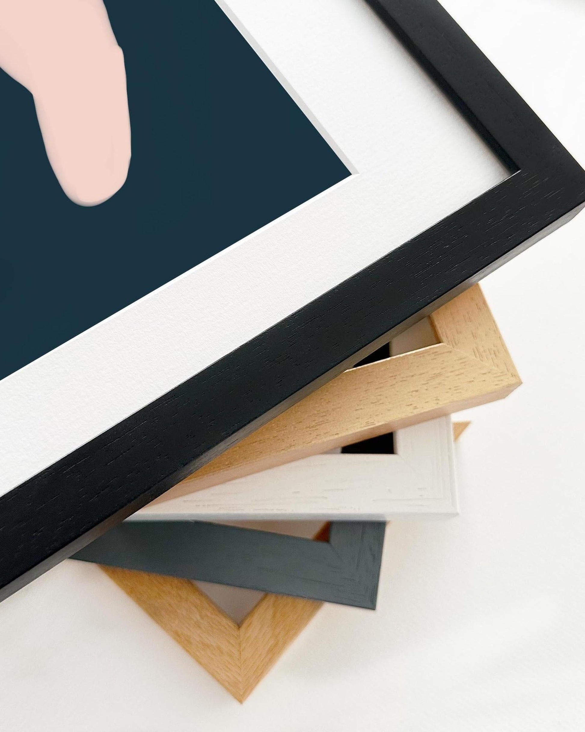 Stack of various photo frames on a white surface