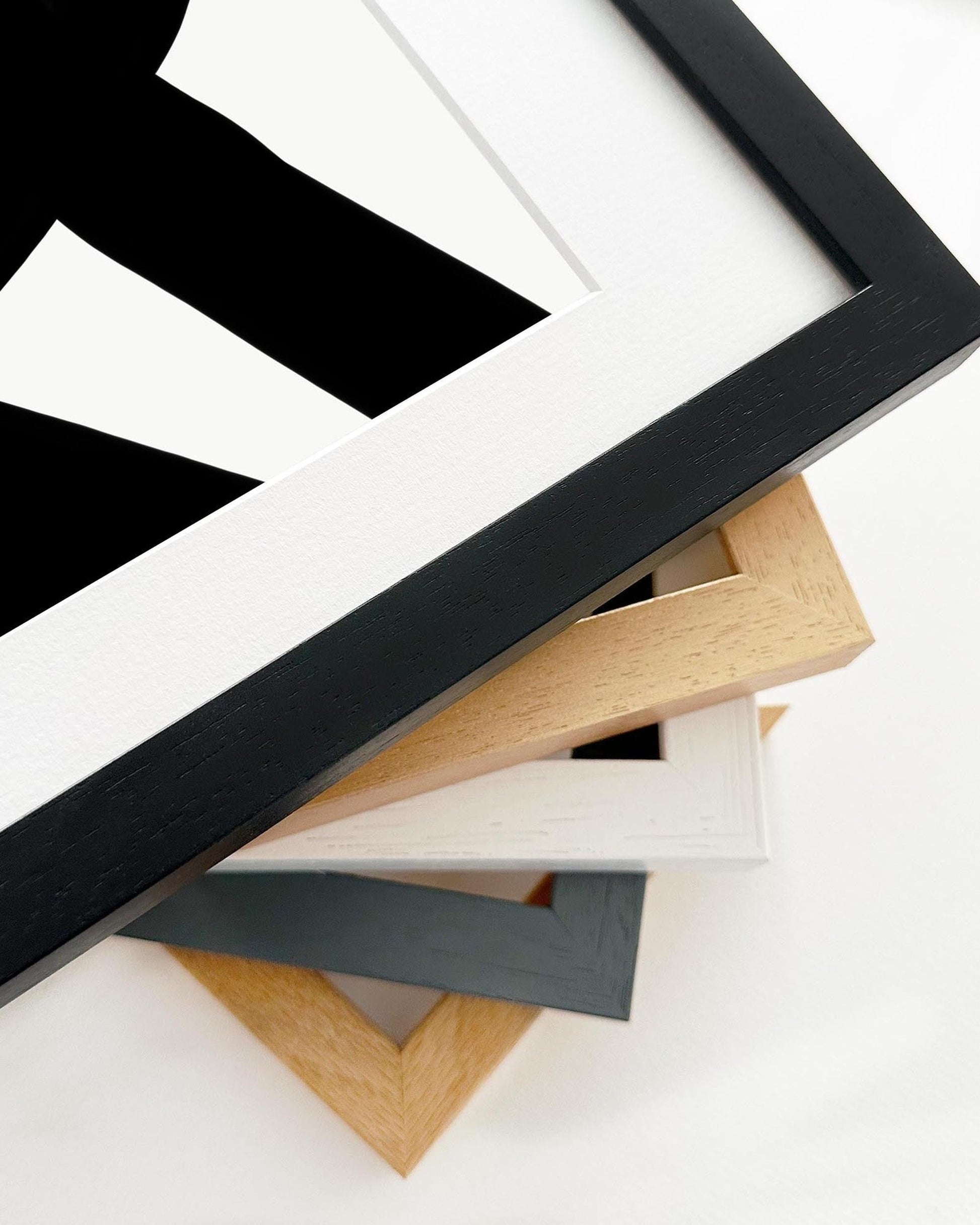 Collection of various wooden picture frames on a white background