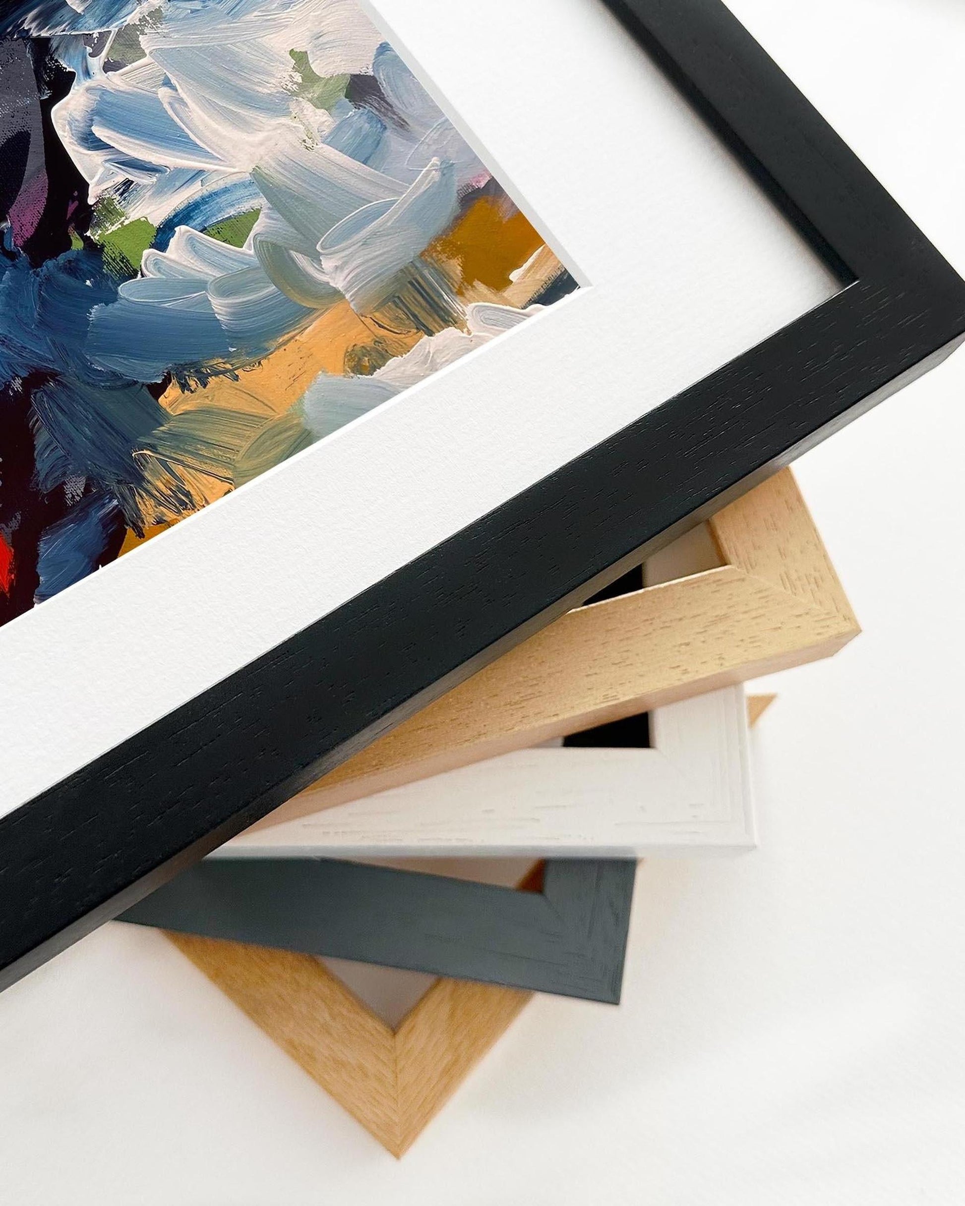 Collection of picture frames in various colors on a white background