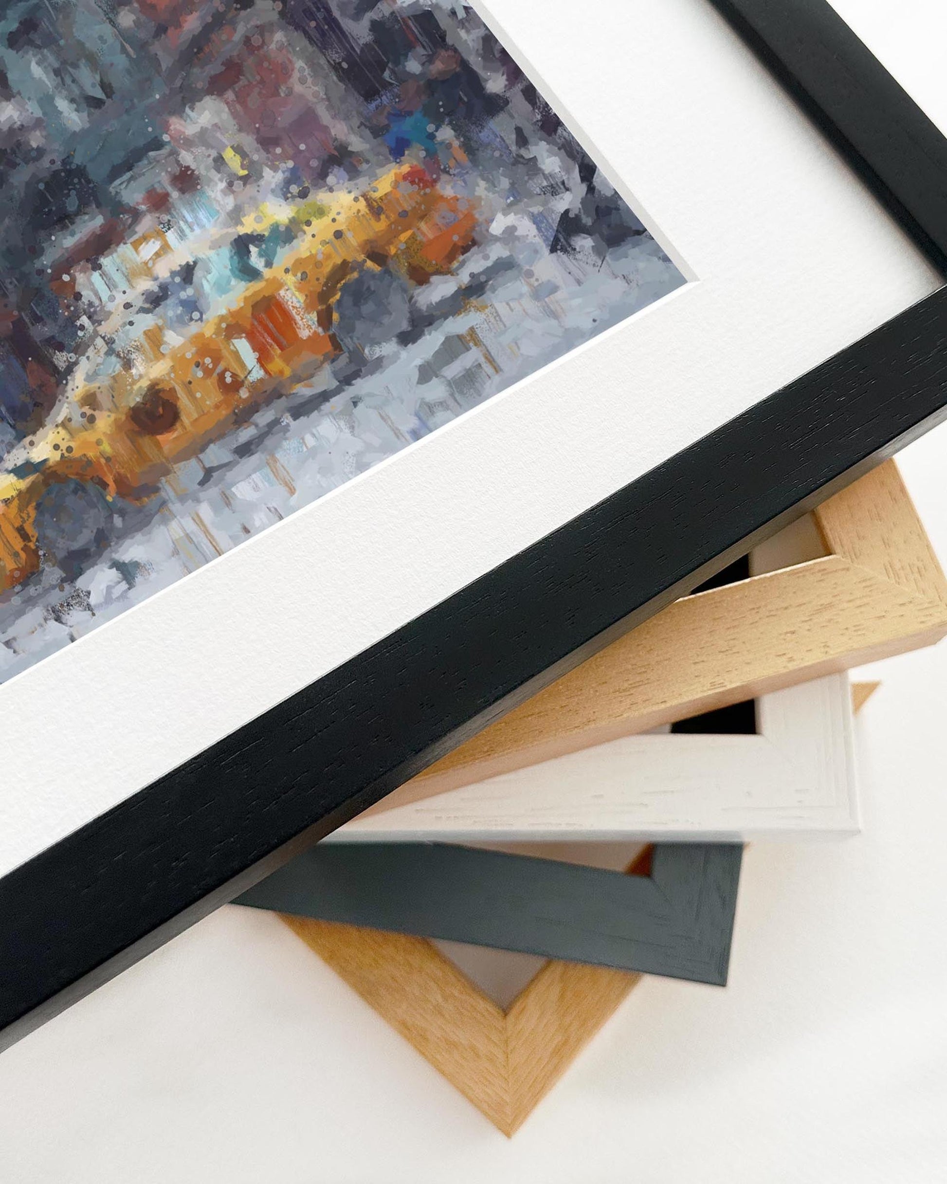 Framed abstract painting with a stack of variously colored frames on a white background
