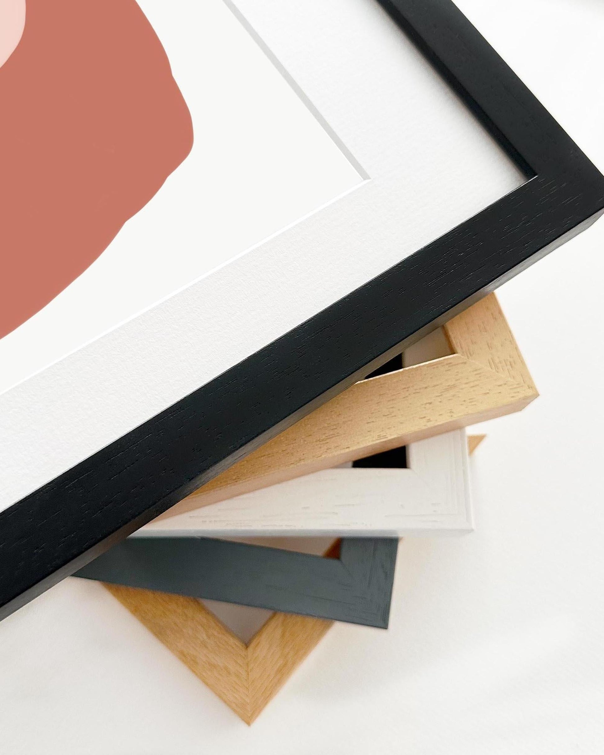 Collection of variously shaped and colored picture frames on a white background