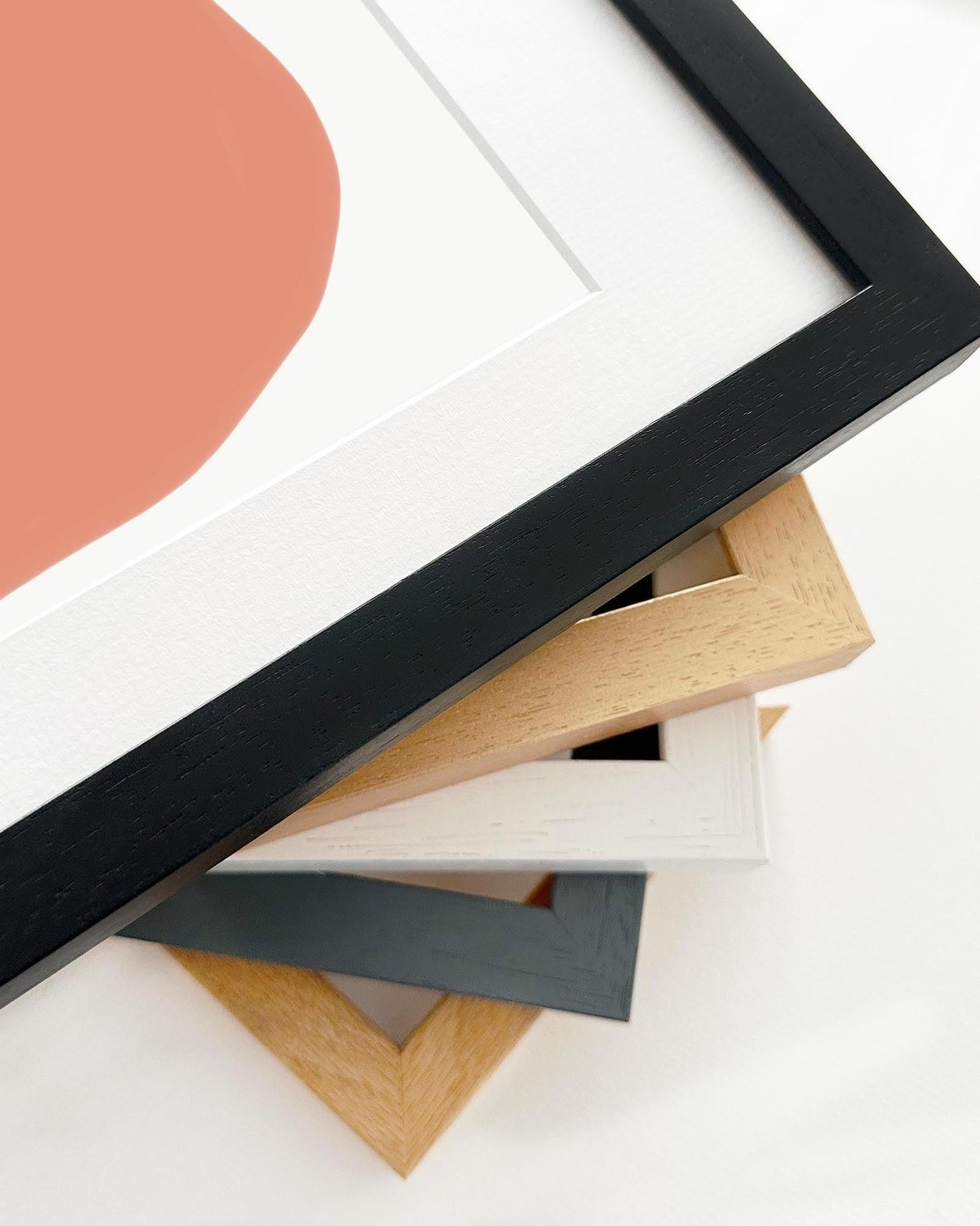 Collection of various wooden picture frames on a white background