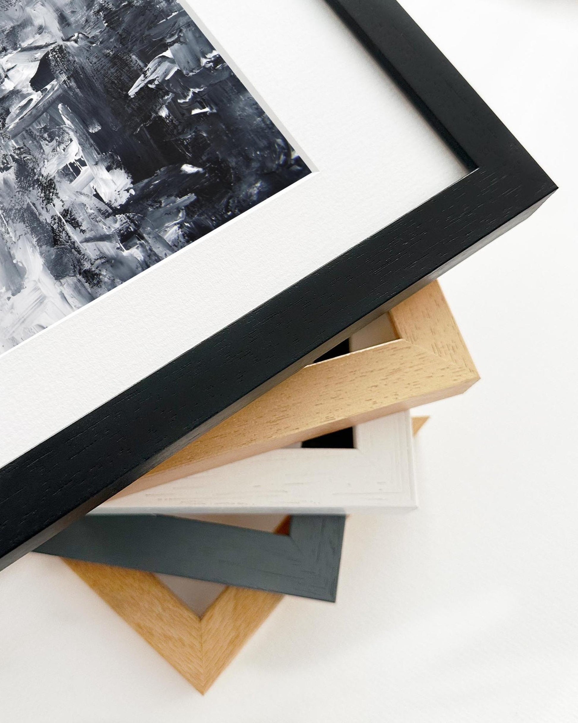 Stack of various picture frames on a white surface