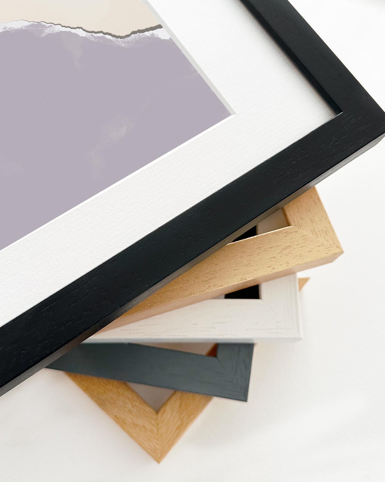 Stack of variously colored picture frames on a white background