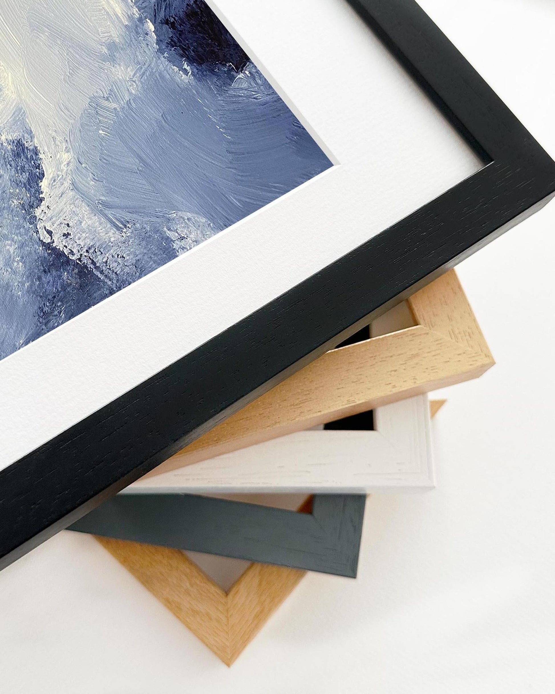 Collection of variously colored picture frames on a white surface