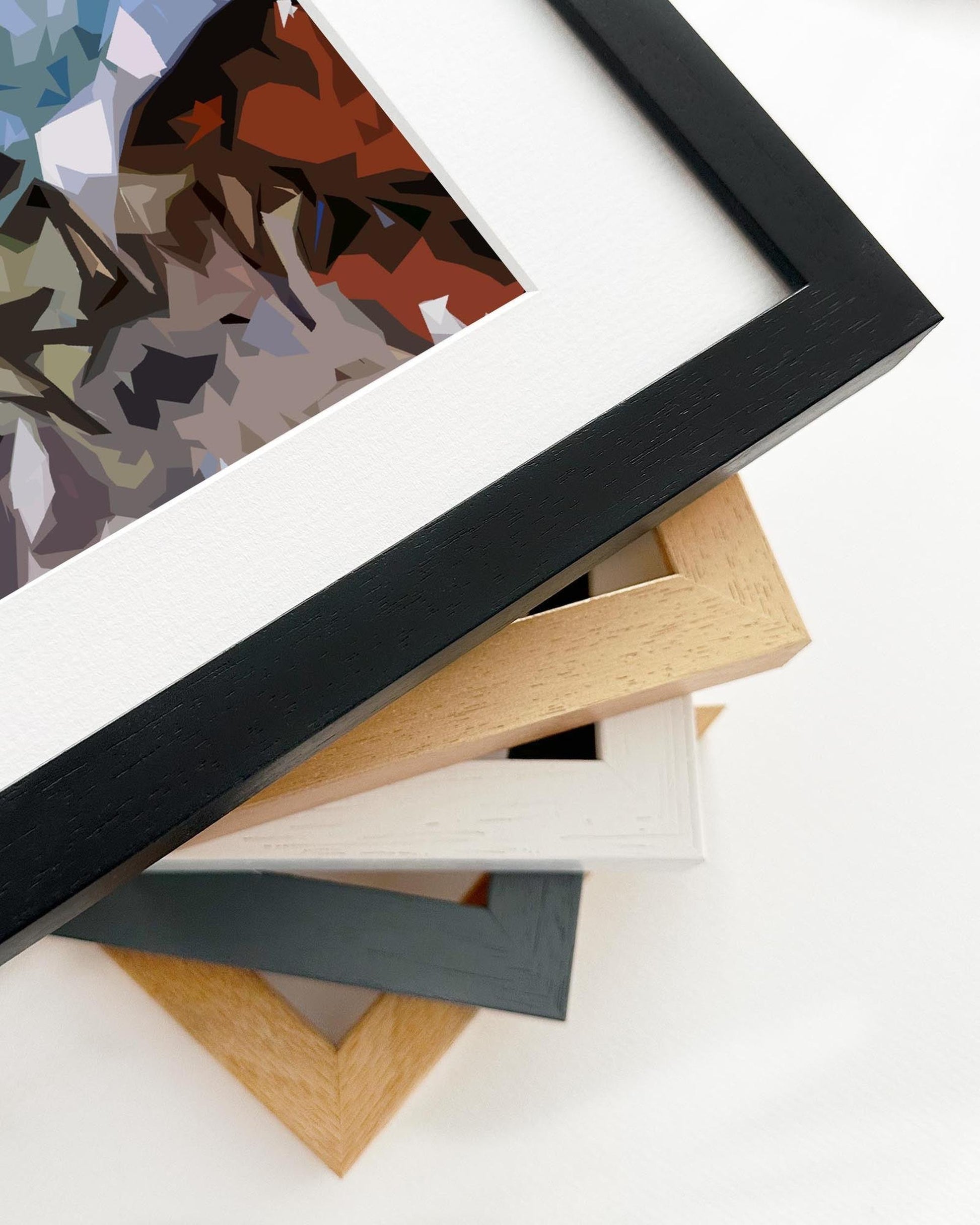 Stack of various wooden picture frames on a white background