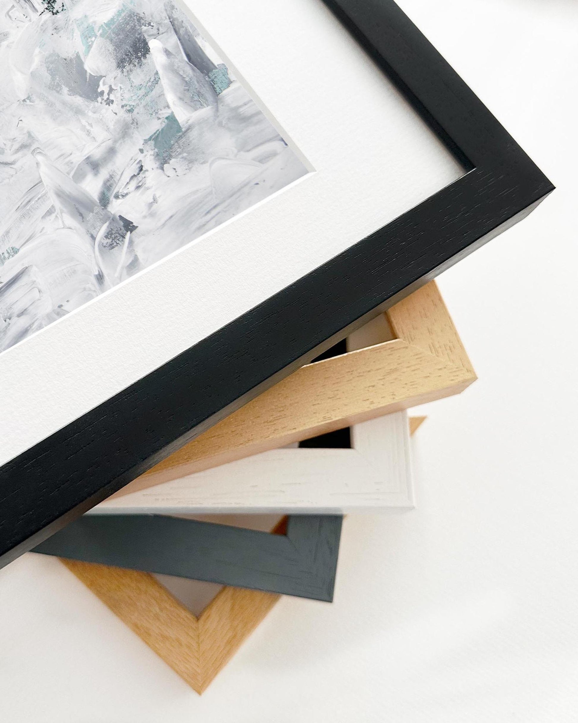 Stack of various photo frames on a white surface