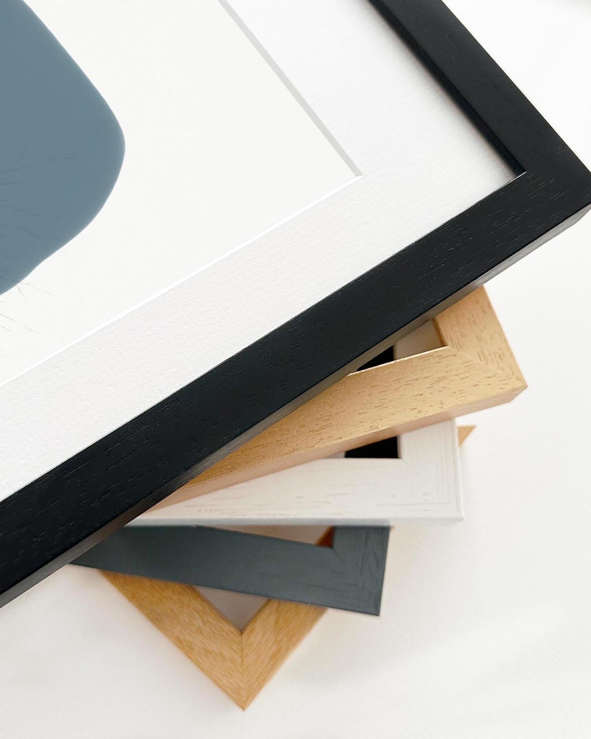 Collection of various wooden picture frames on a white background