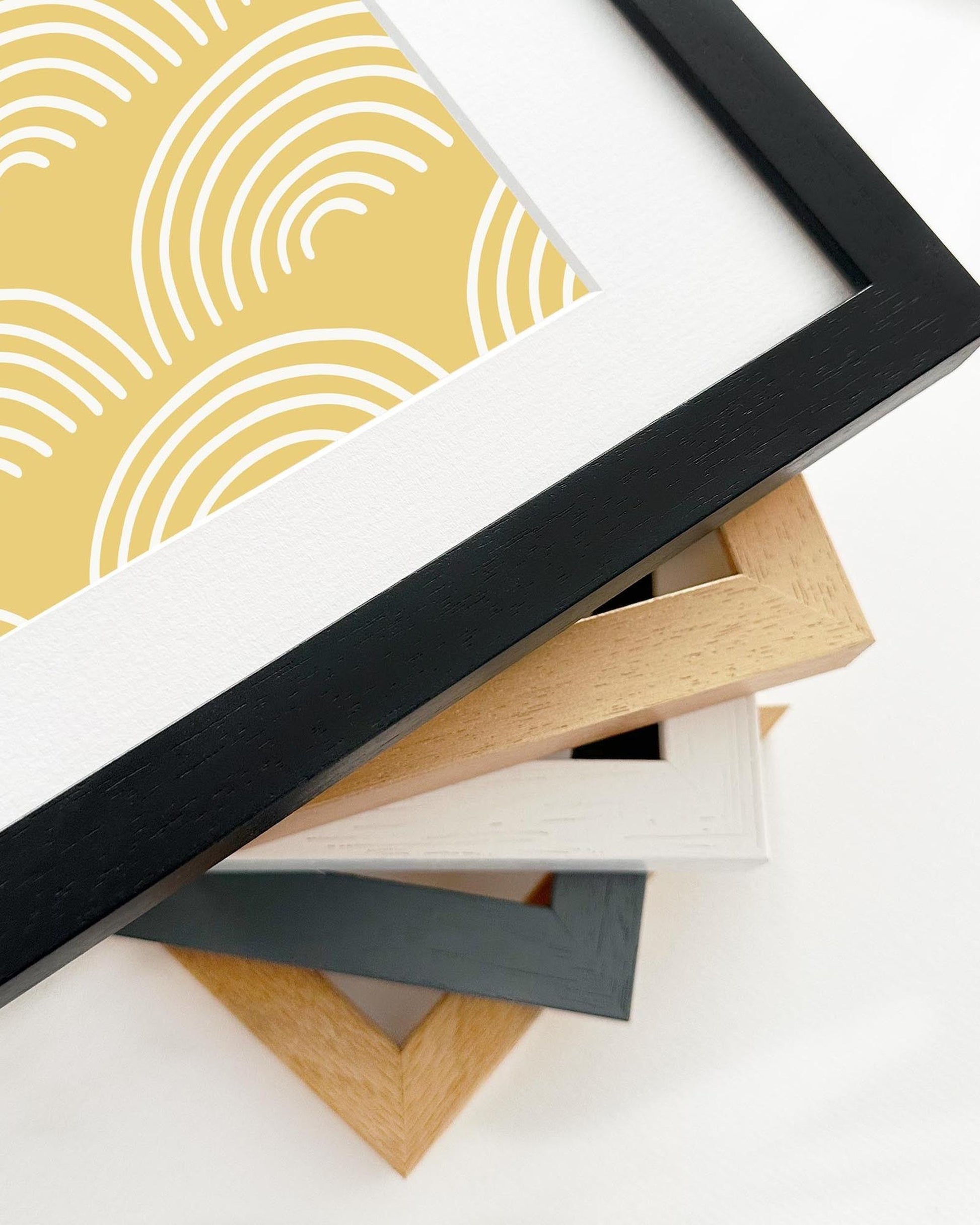 Stack of variously colored picture frames on a white background