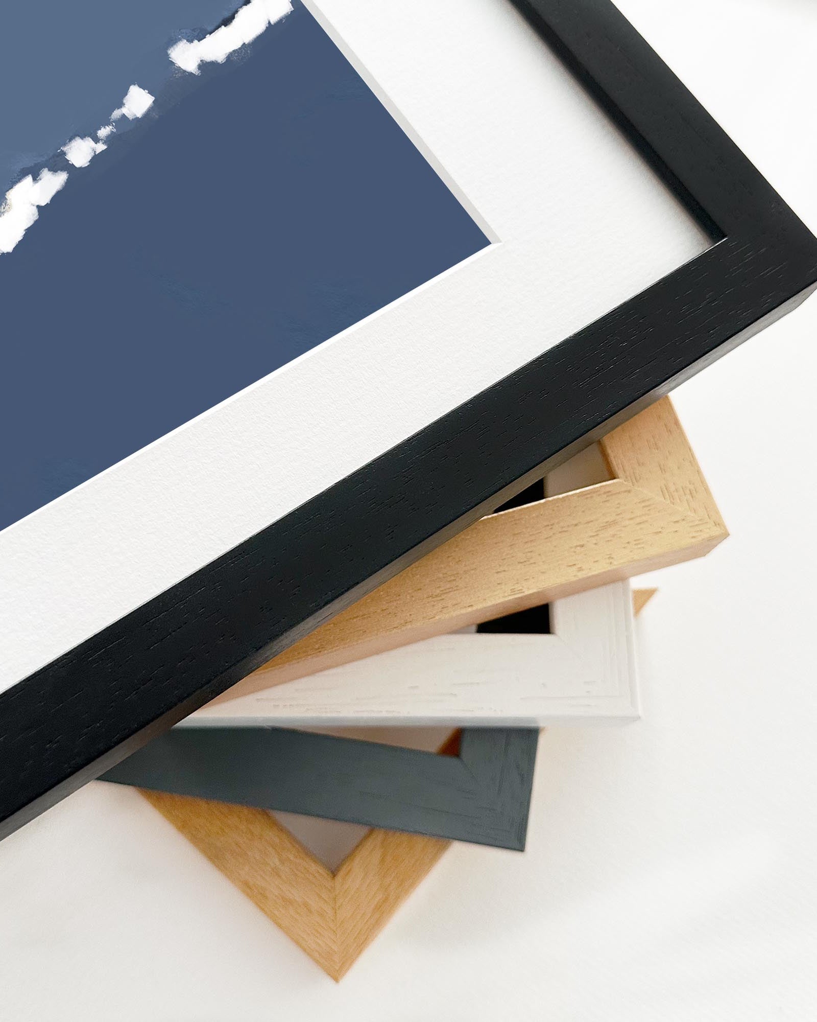 Stack of variously colored picture frames on a white background