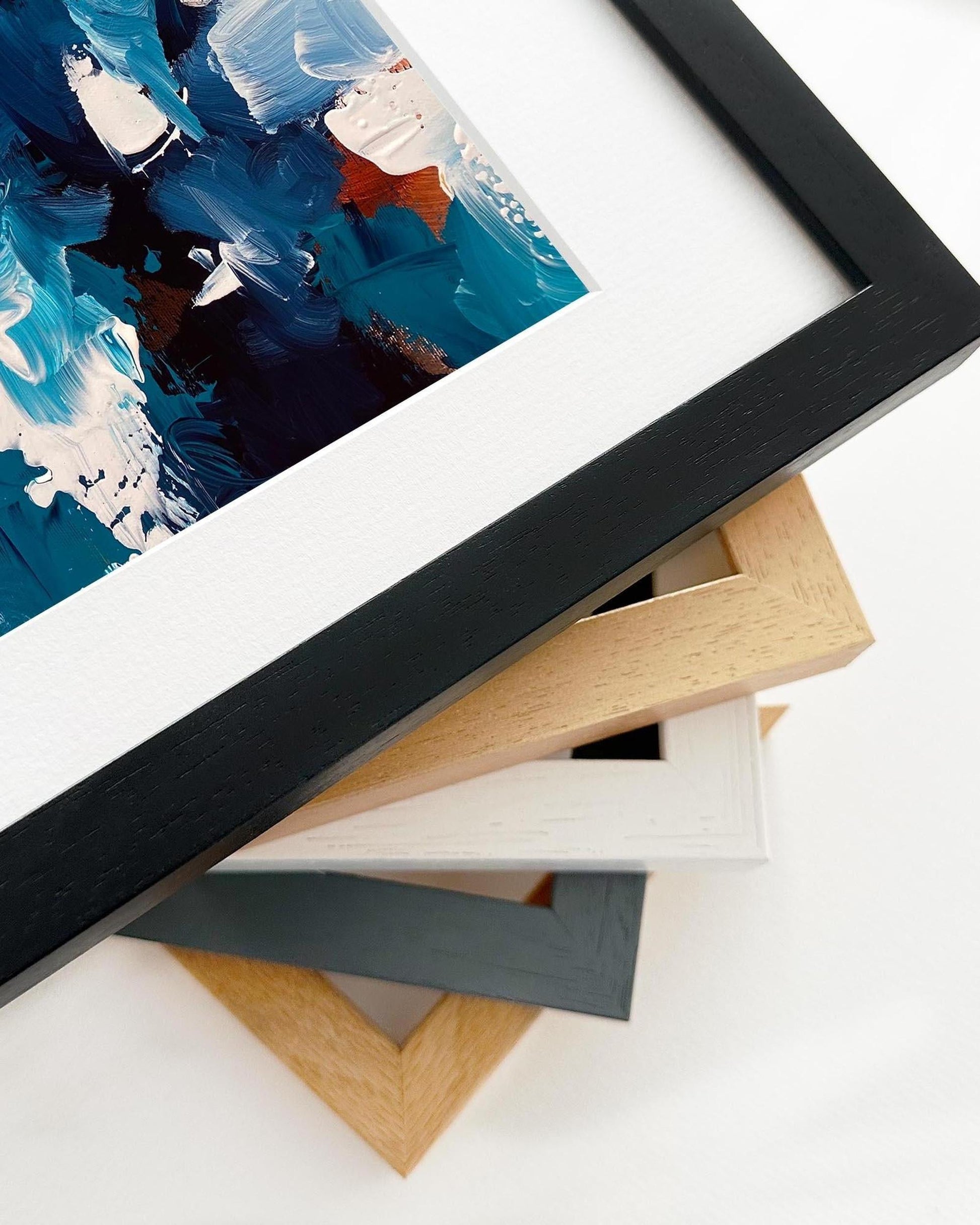 Framed artwork with a black frame on a white surface