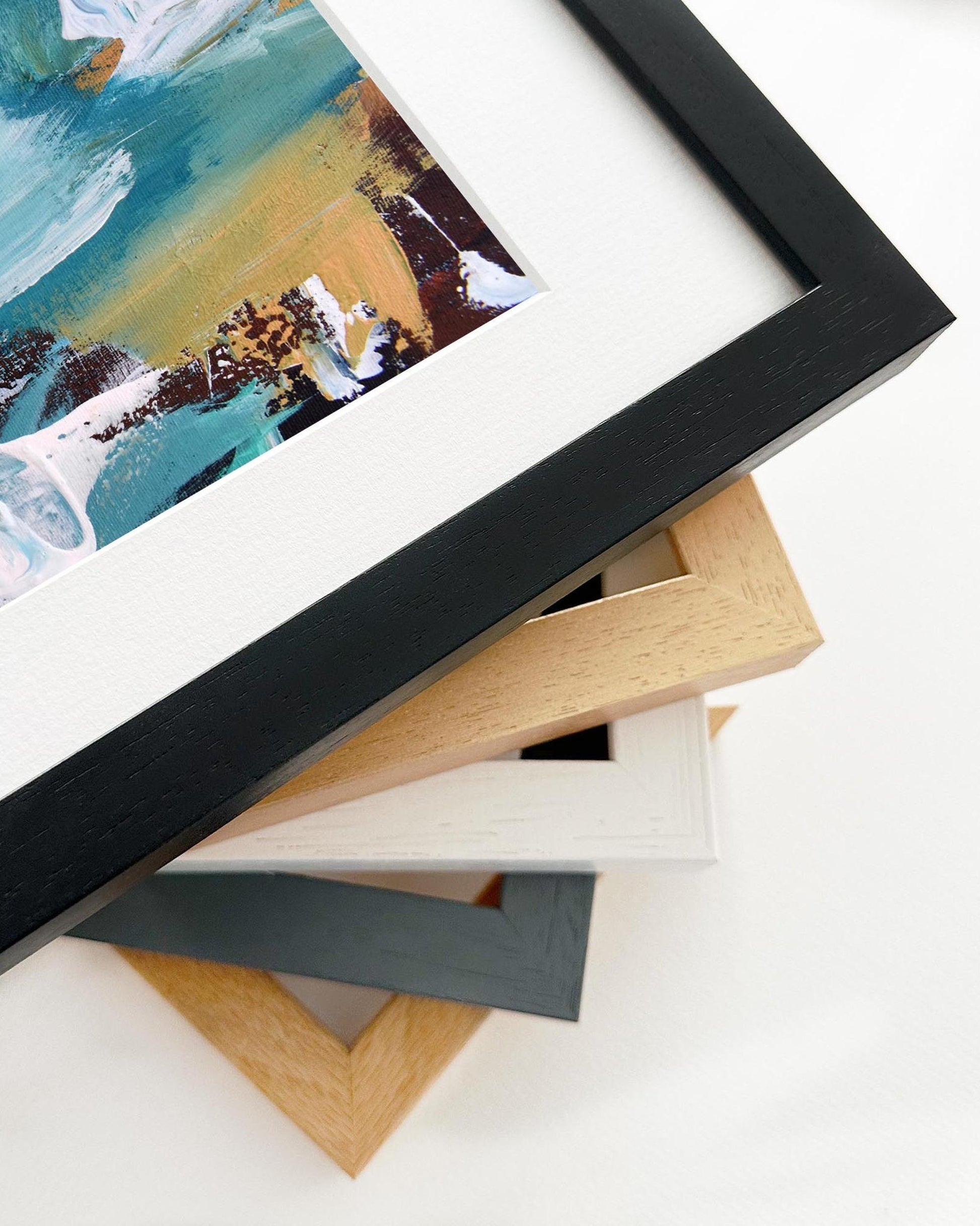 Framed abstract artwork with a stack of variously colored frames on a white background