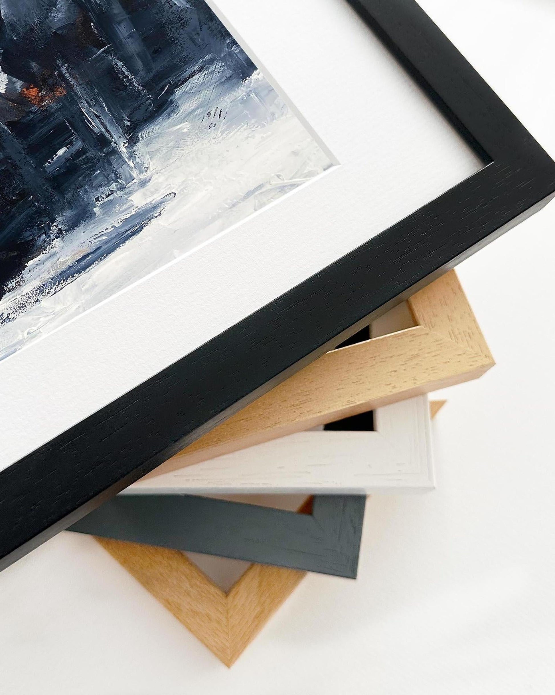 Close-up of various picture frames on a white surface