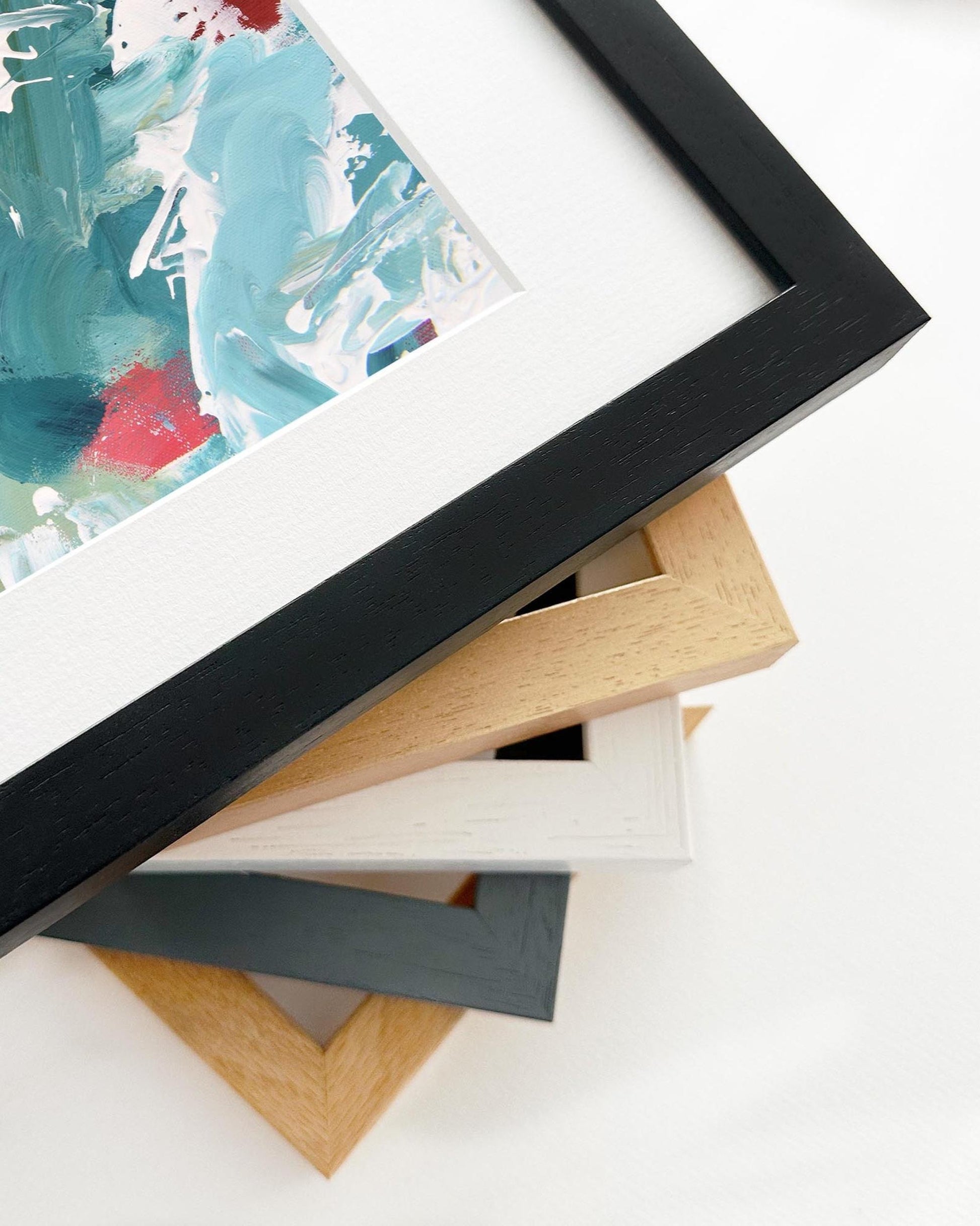 Stack of variously colored picture frames on a white background