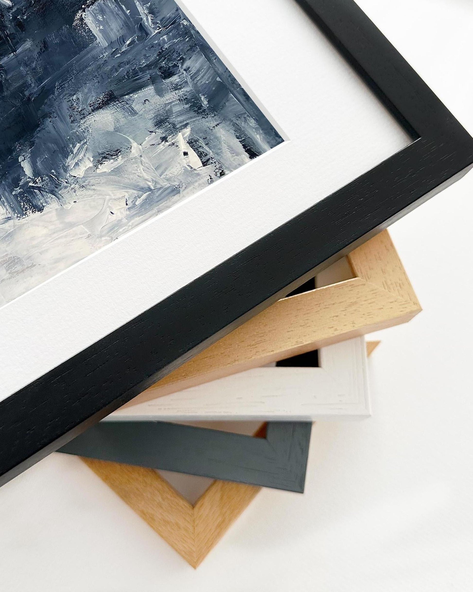 Close-up of various picture frames on a white surface