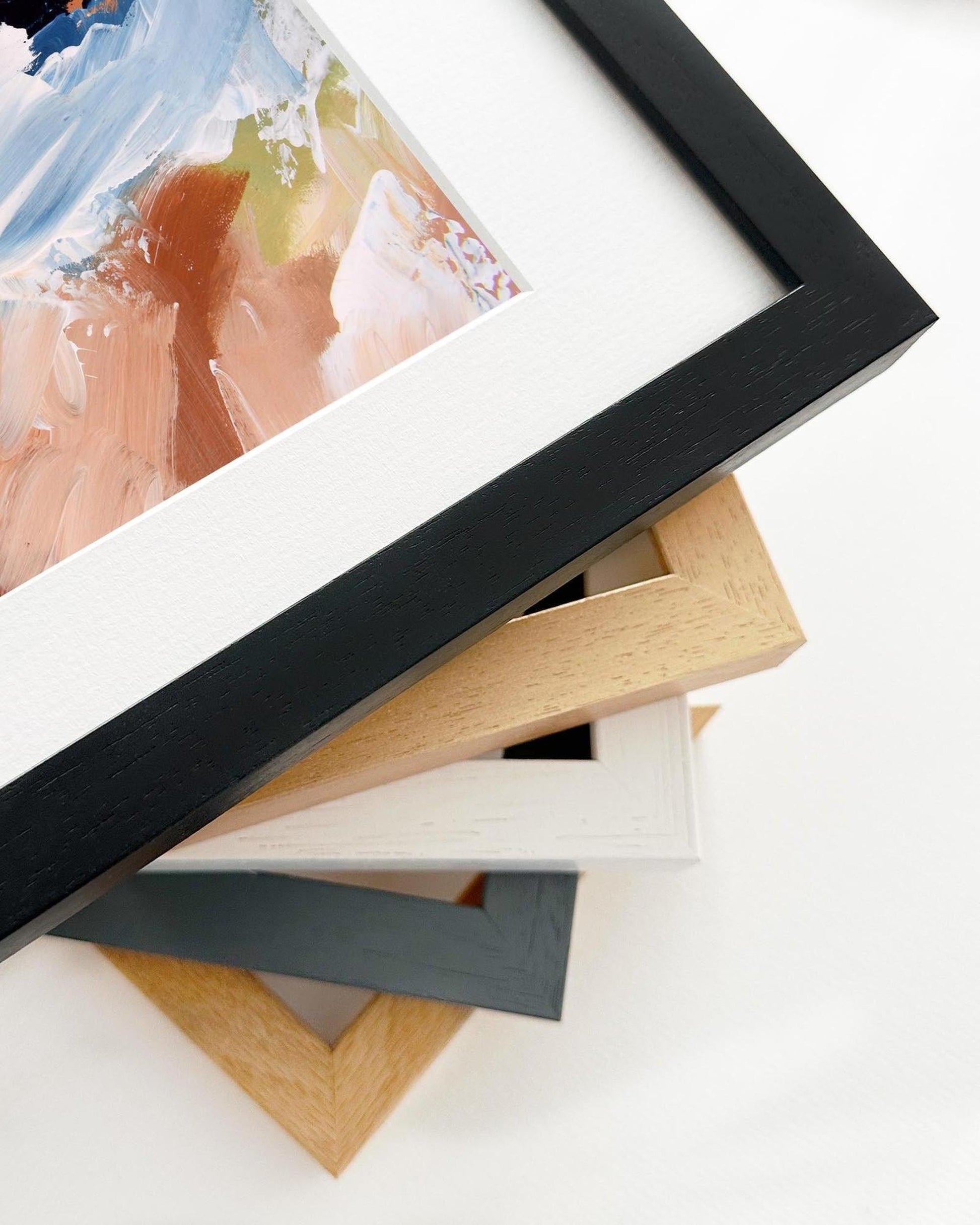Stack of various photo frames on a white surface