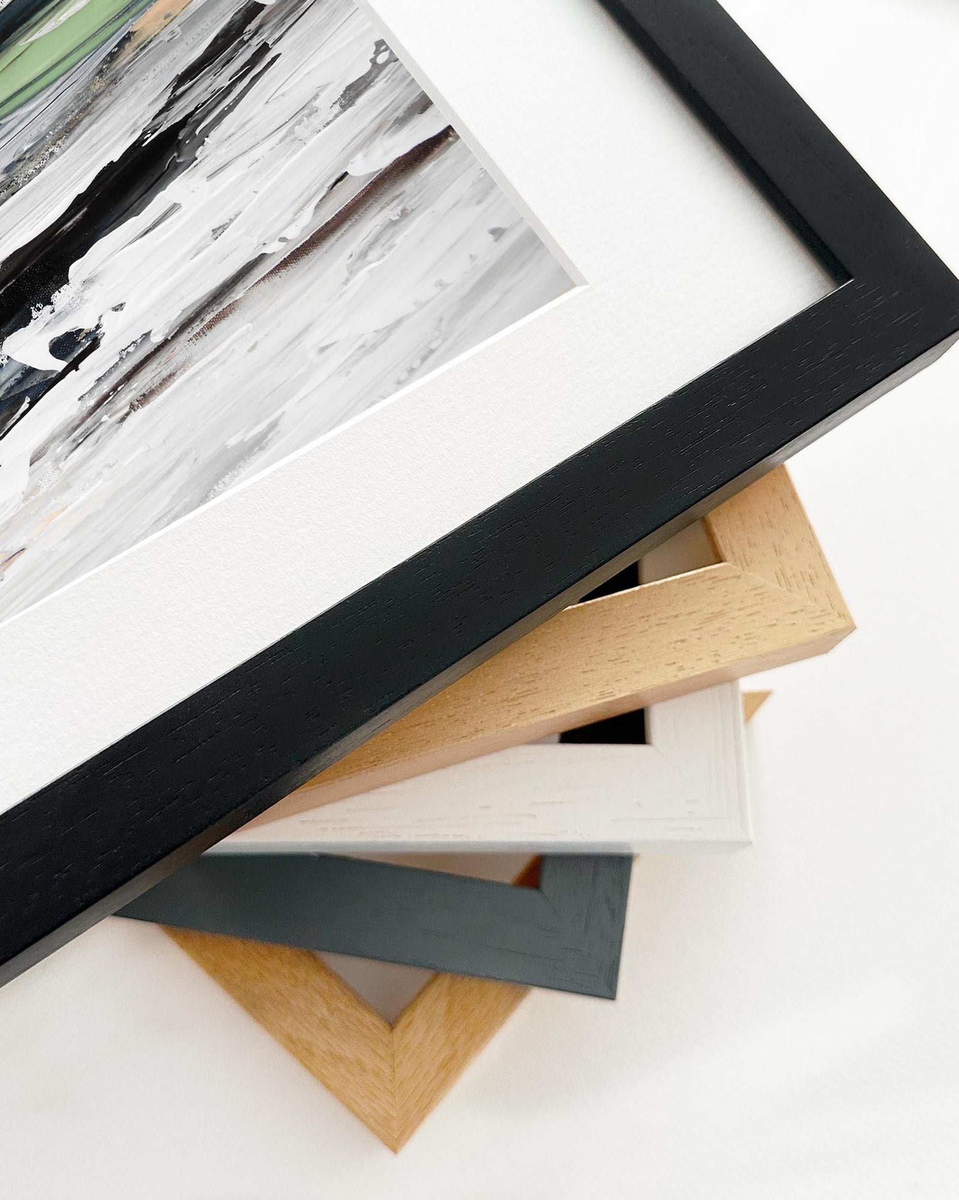 Stack of various photo frames on a white surface