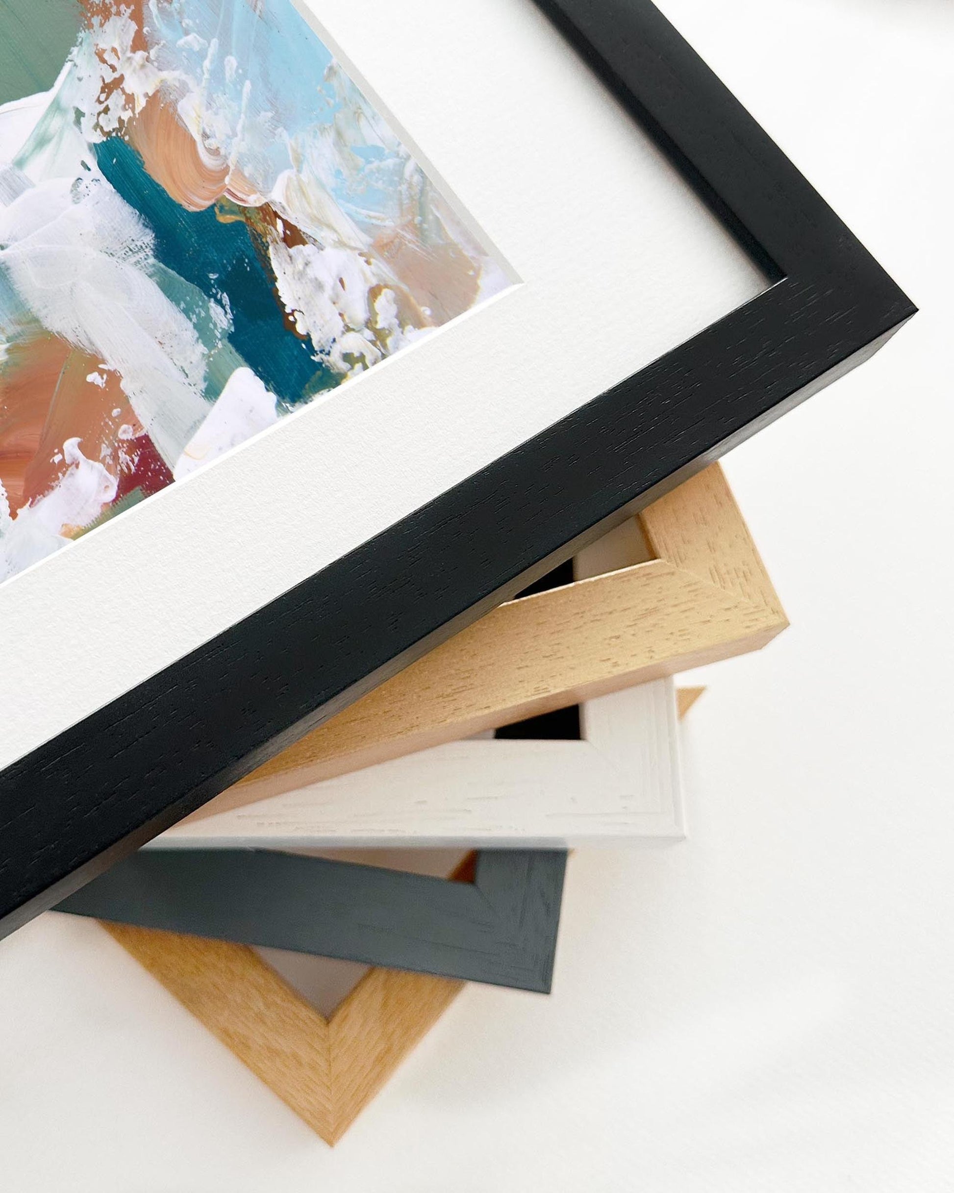 Stack of various photo frames on a white surface