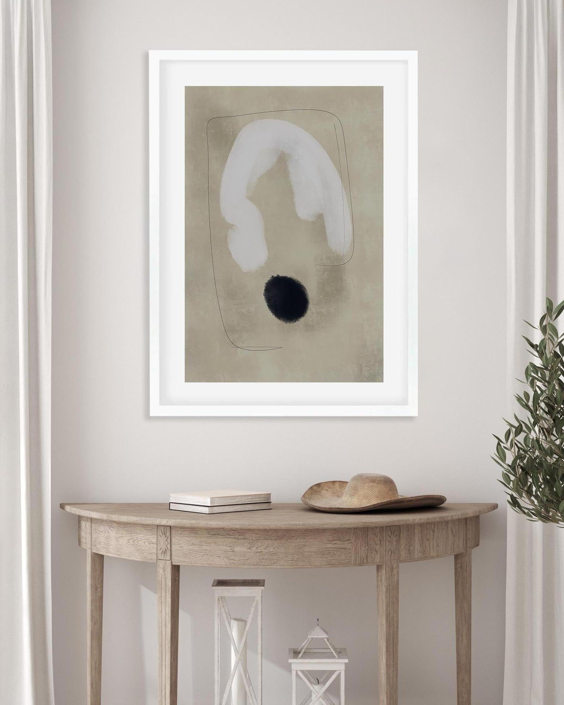Framed abstract art piece on a wall above a wooden console table.