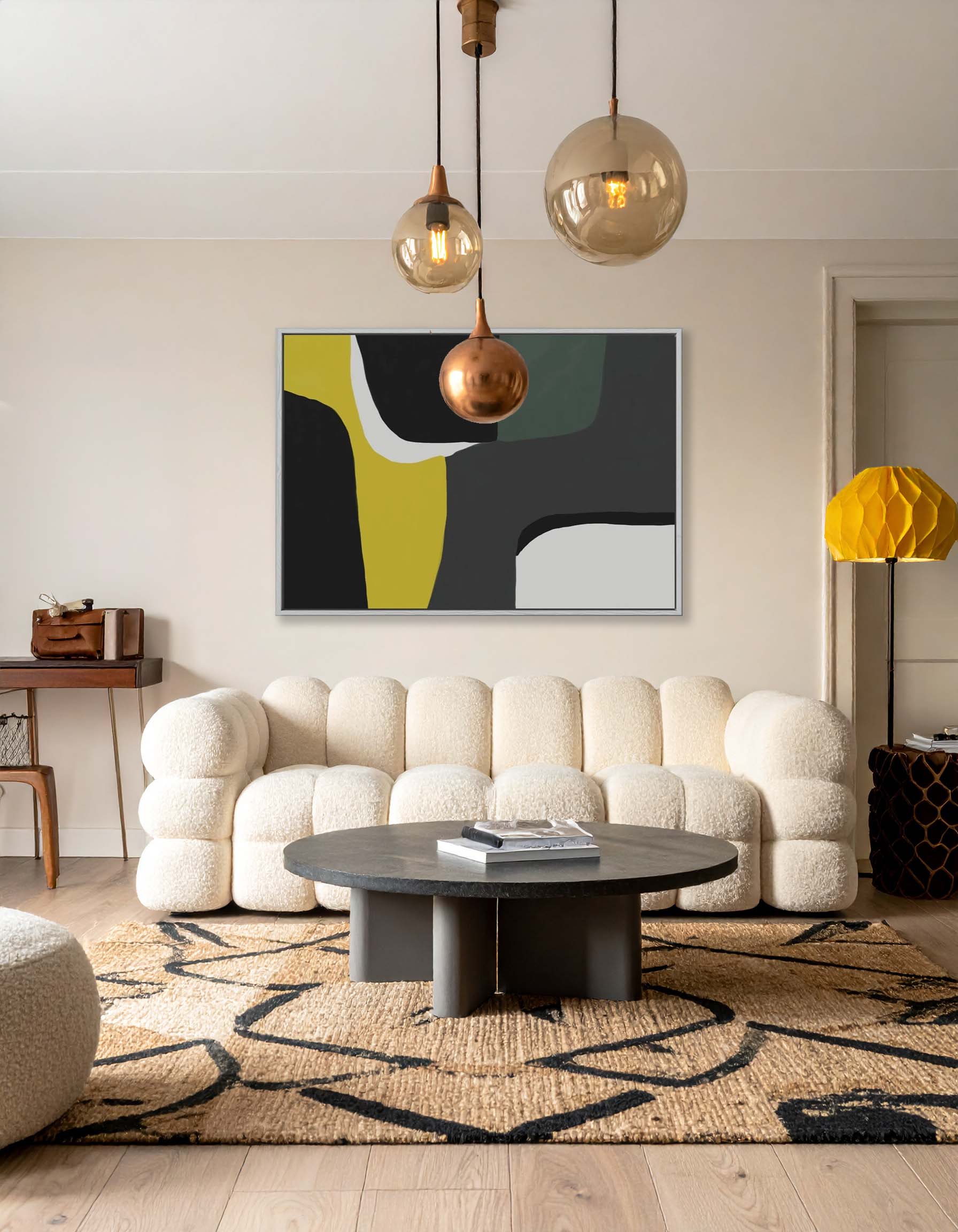 Modern living room with a beige sofa, round coffee table, and abstract art on the wall.