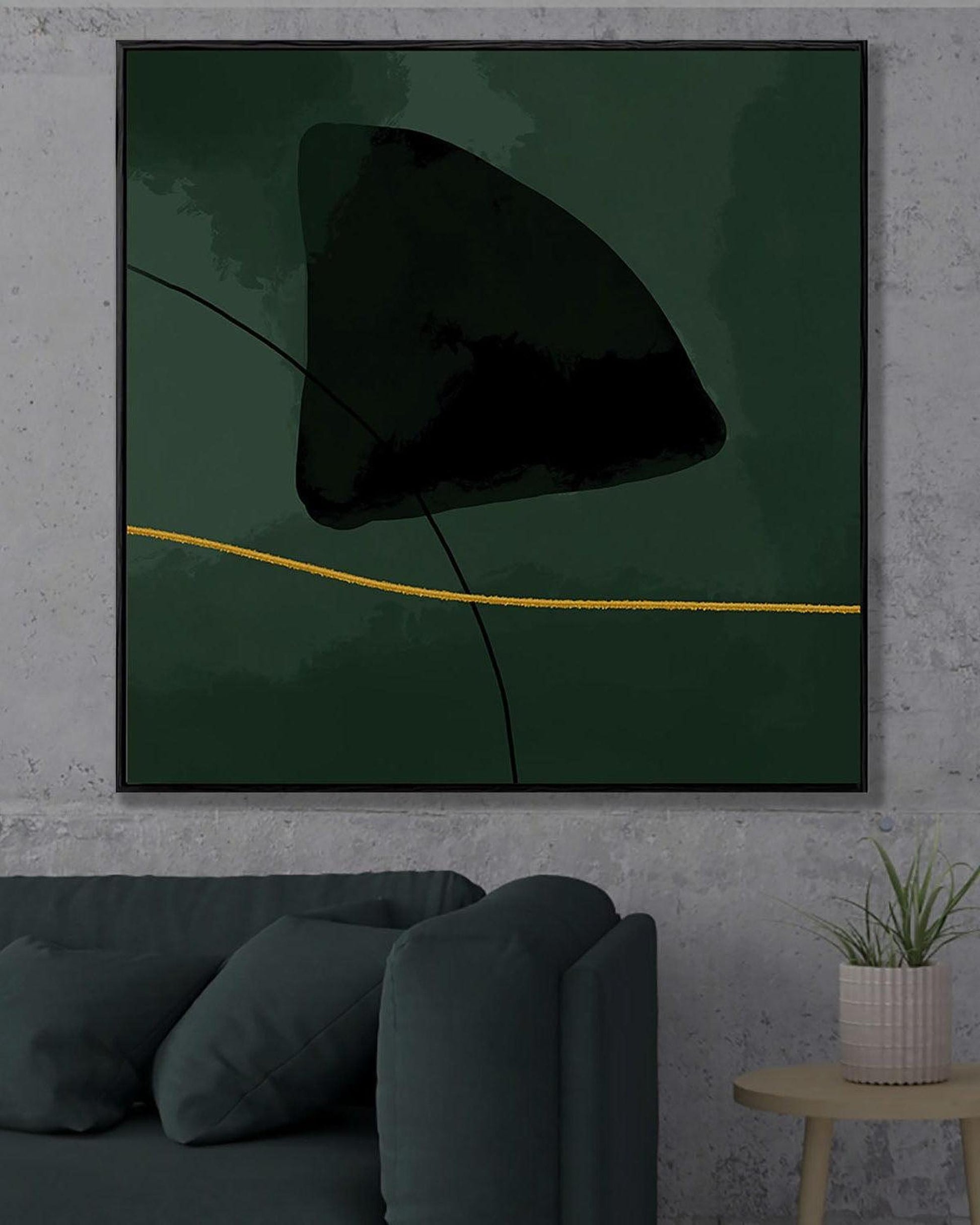 Abstract art piece with a black shape and yellow line on a green background, displayed in a modern living room.