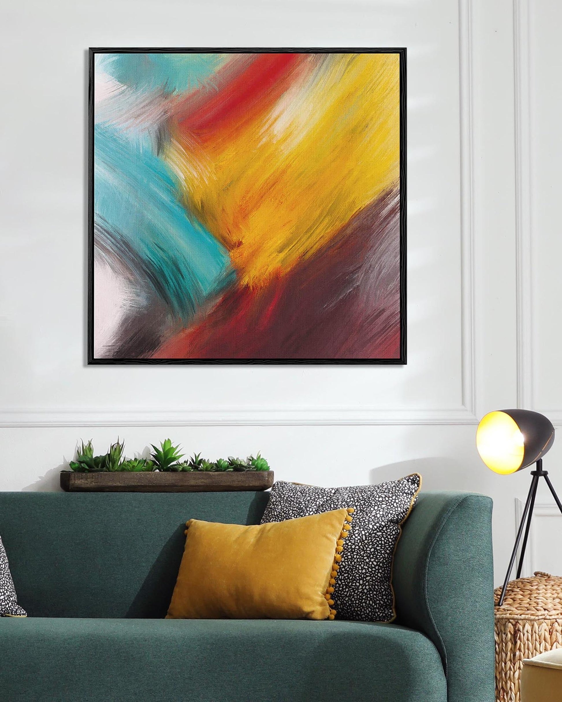 Colorful abstract painting above a sofa with decorative pillows in a living room setting.