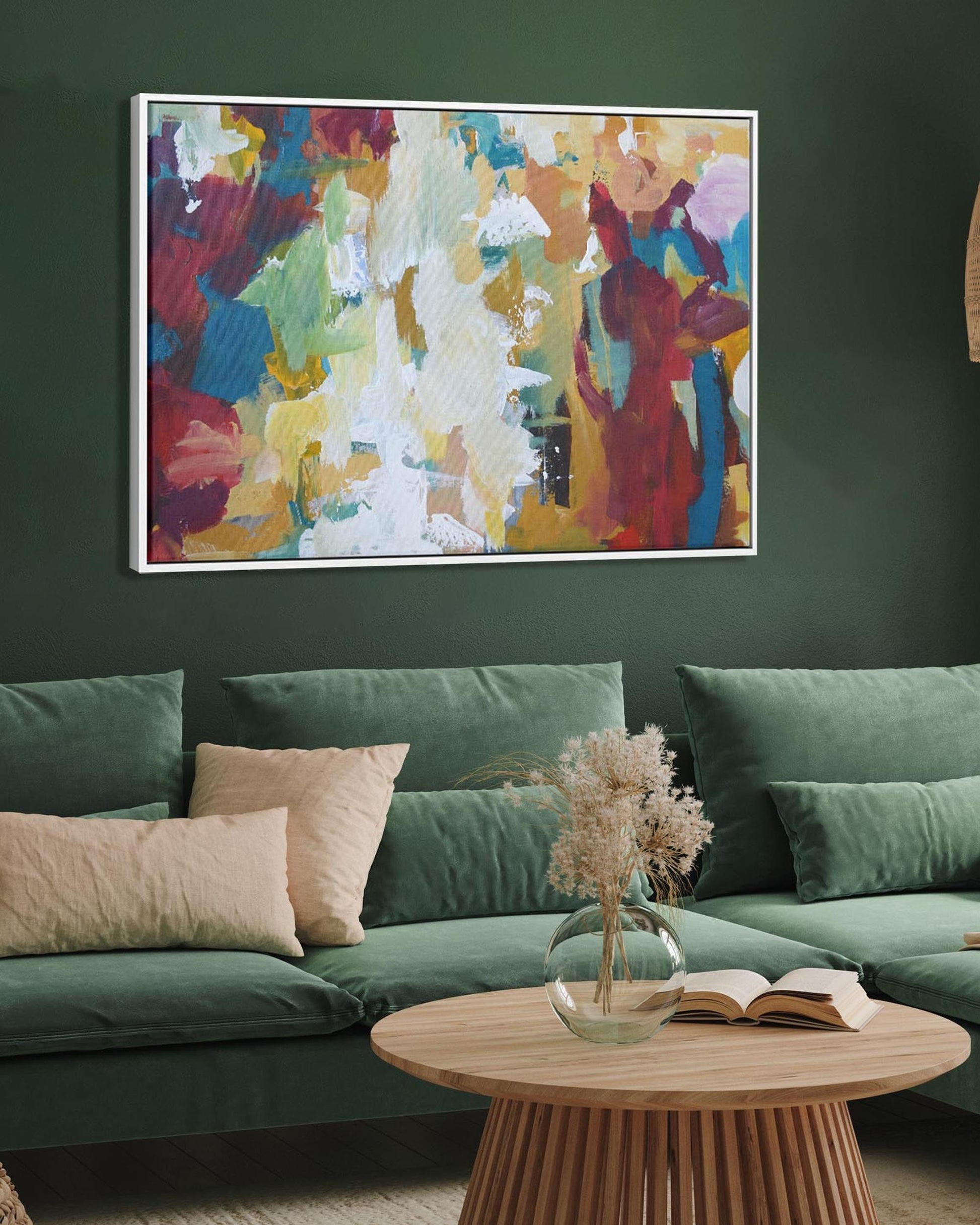 Living room with green sofa, abstract painting, and wooden coffee table.