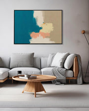 Modern living room with a gray sectional sofa, wooden coffee table, and abstract art on the wall.