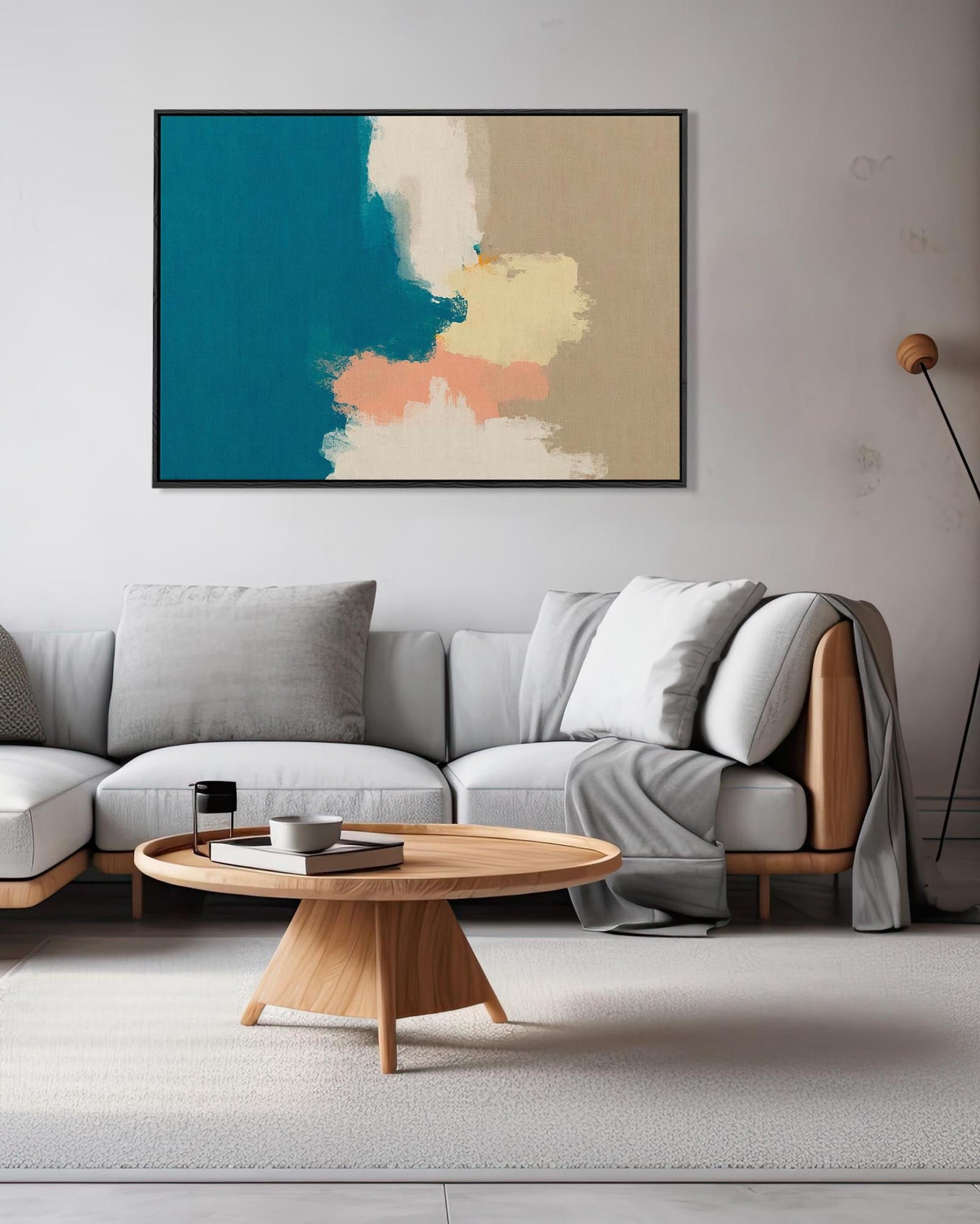 Modern living room with a gray sectional sofa, wooden coffee table, and abstract art on the wall.