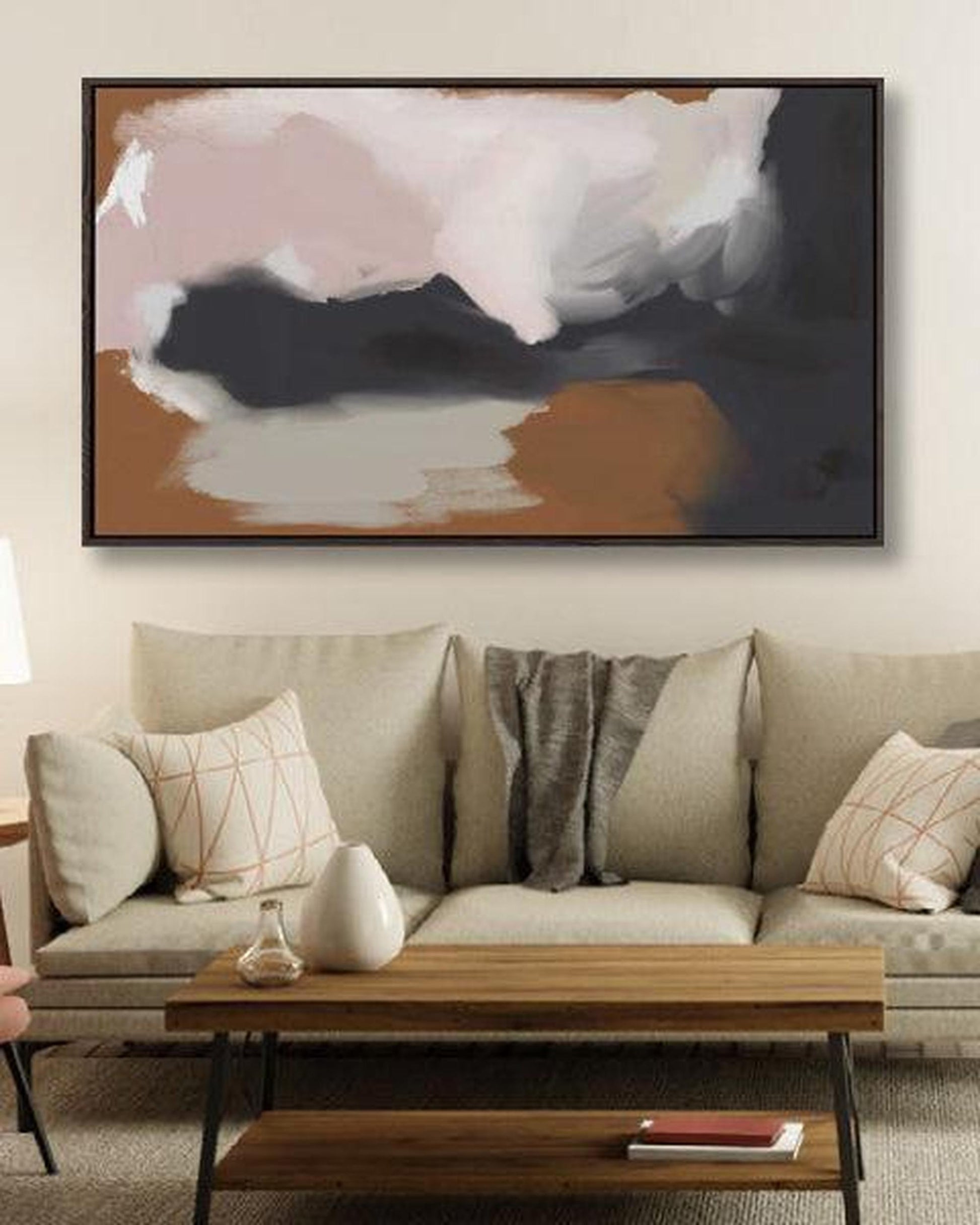 Living room with a beige sofa, wooden coffee table, and abstract painting on the wall.
