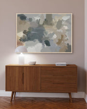 Wooden sideboard with abstract painting above it in a room.