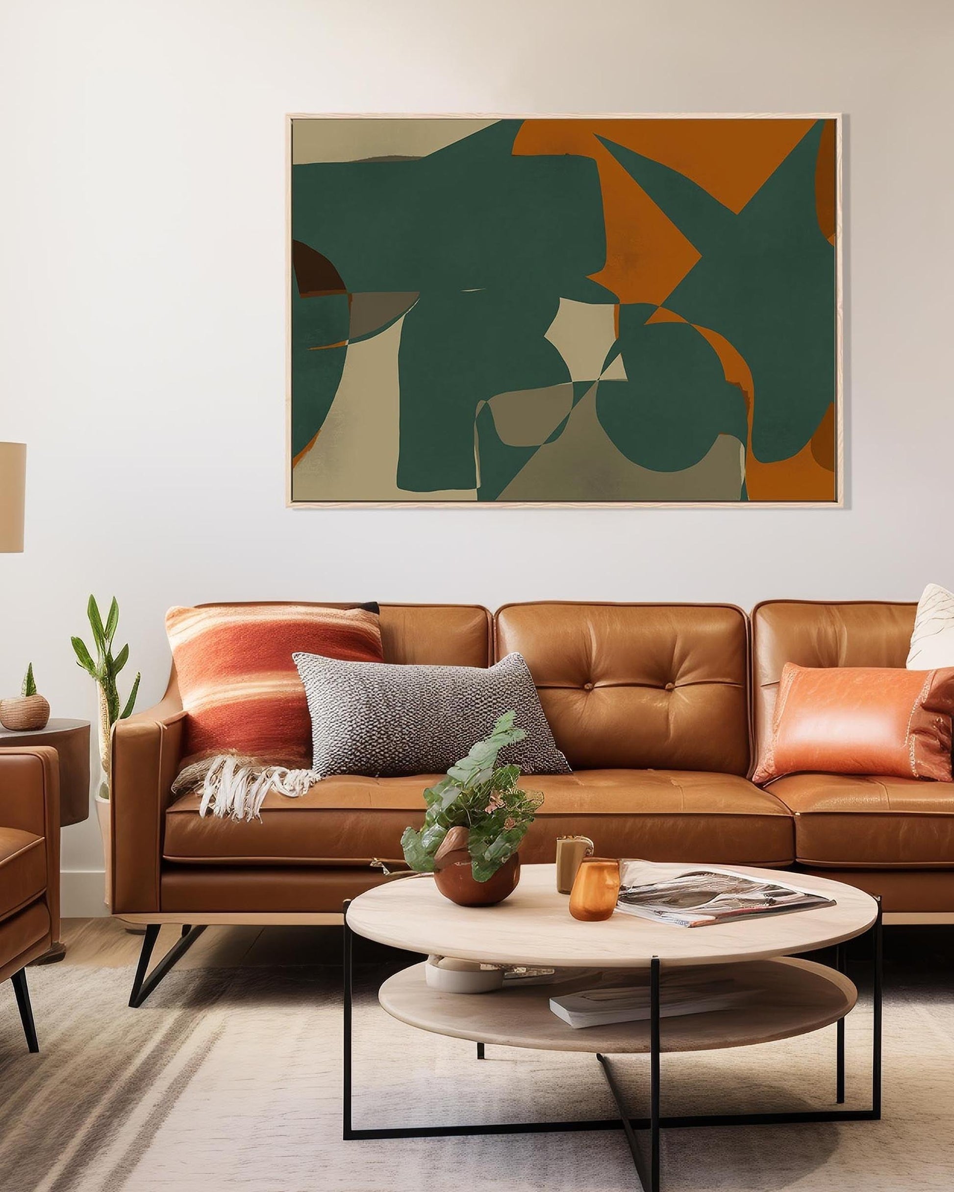 Modern living room with brown leather sofa, abstract art, and coffee table.