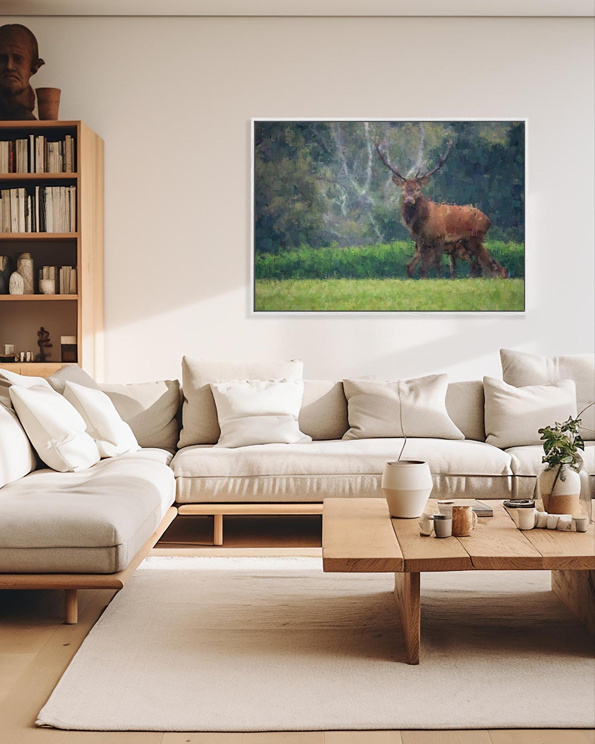 Modern living room with a sofa, coffee table, and wall art of a deer.