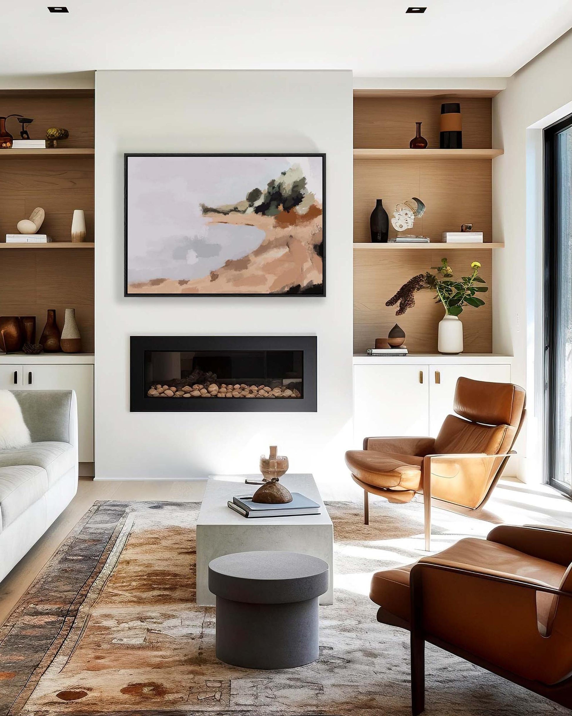 Modern living room with brown chairs, white sofa, and abstract painting above a fireplace.