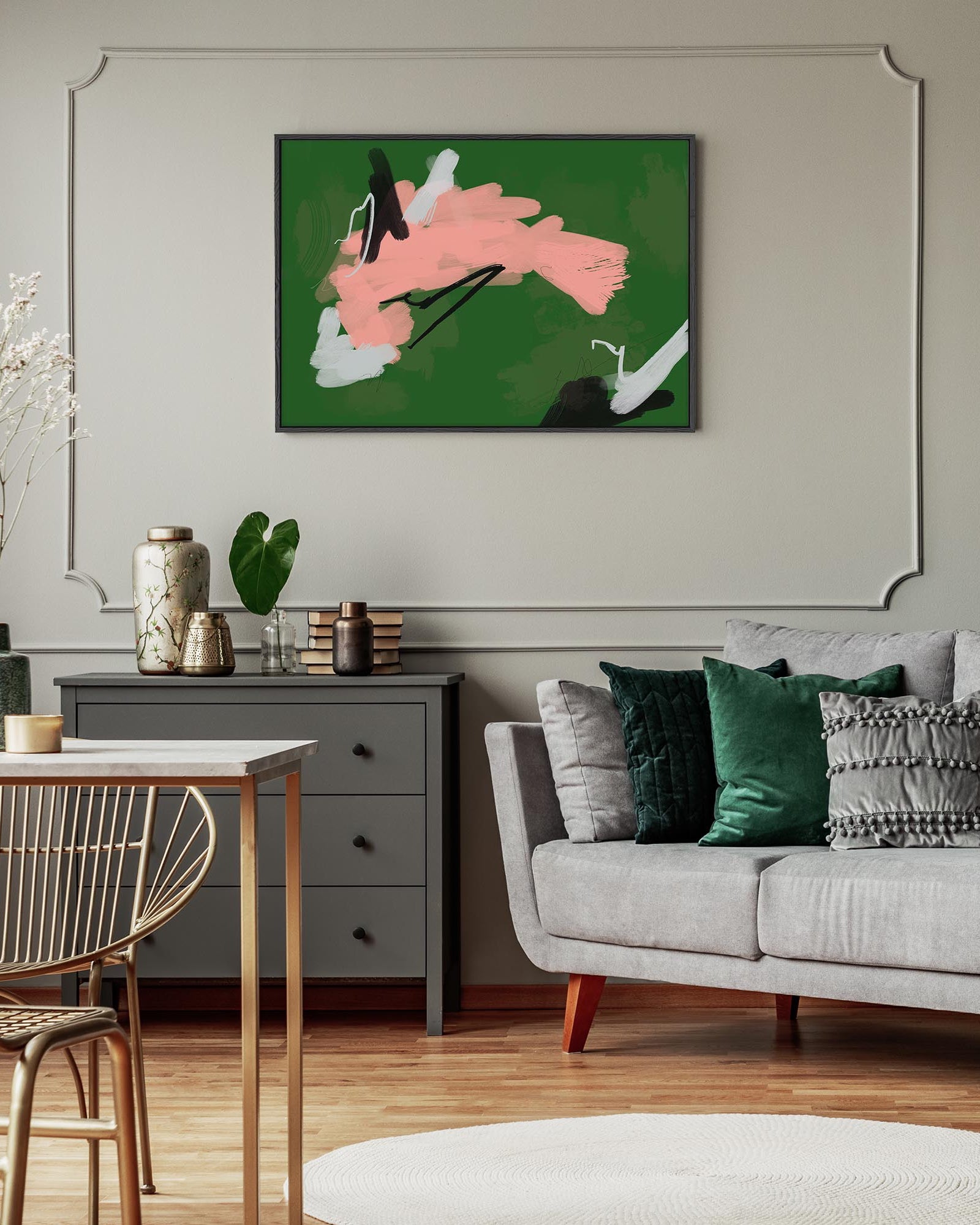 Living room with a gray sofa, abstract painting on the wall, and a small table.