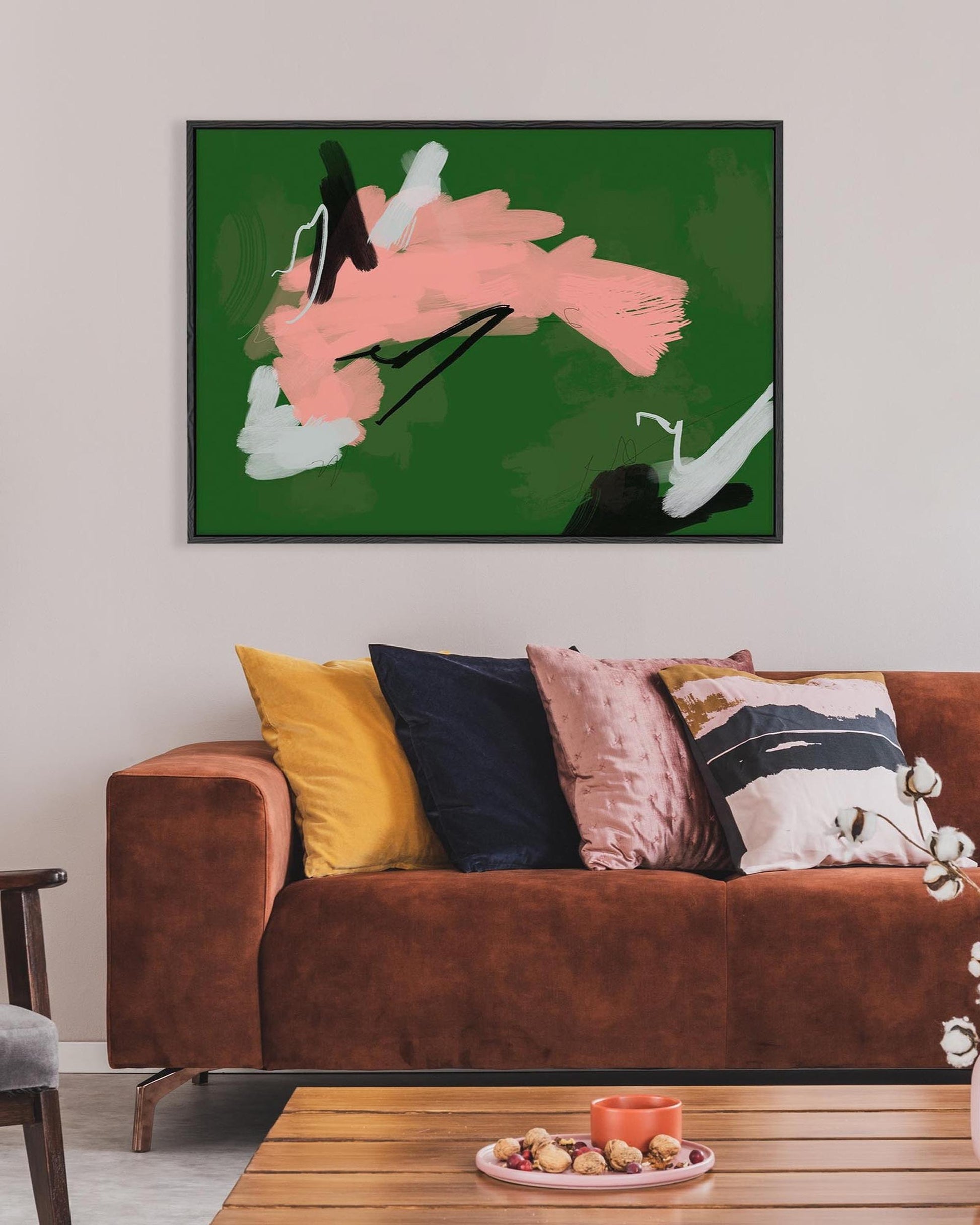 Abstract painting above a brown sofa with colorful cushions in a living room setting.