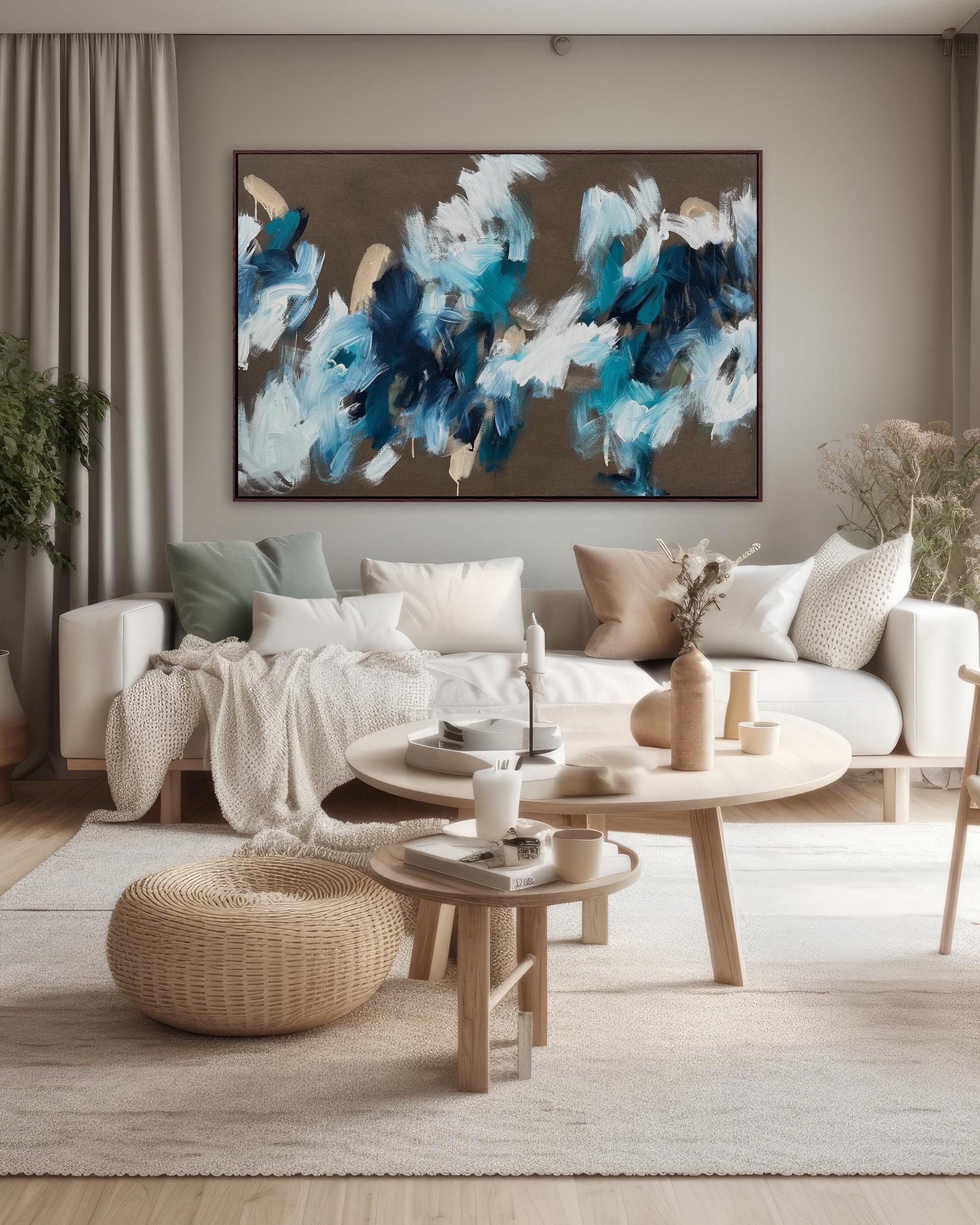 Large oil painting with brown and teal blue colour palette, hanging above a cream sofa in a modern, neutral living room.