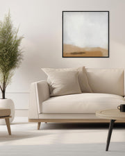 Modern living room with a beige sofa, coffee table, and framed artwork on the wall.