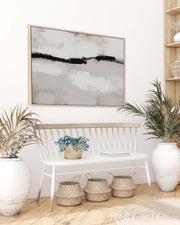 Modern interior with abstract art, plants, and a bench.