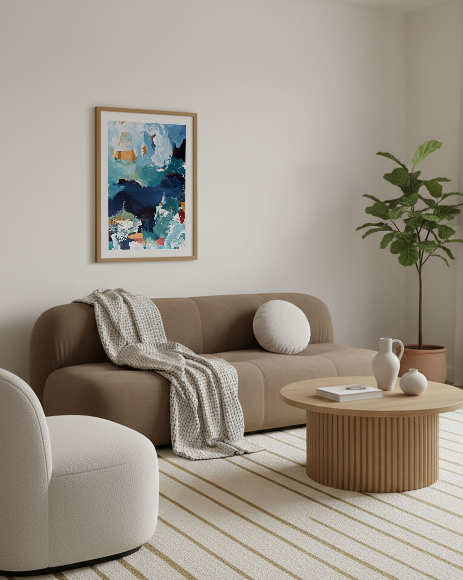 Modern living room with a beige sofa, armchair, coffee table, and abstract art on the wall.