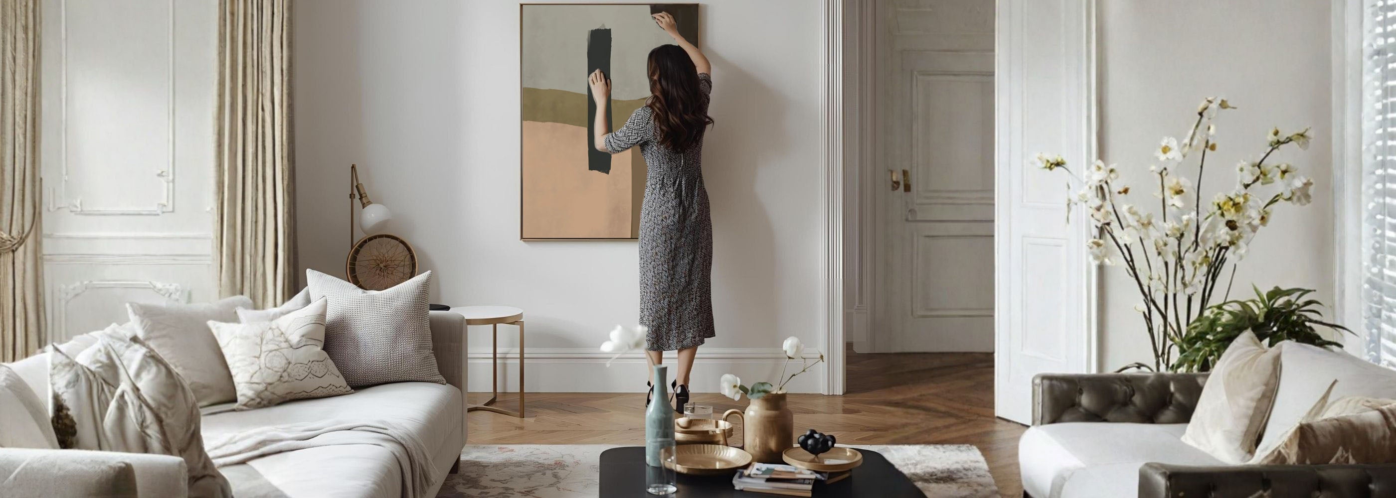 Woman in a gray dress standing in a stylish living room with modern decor.