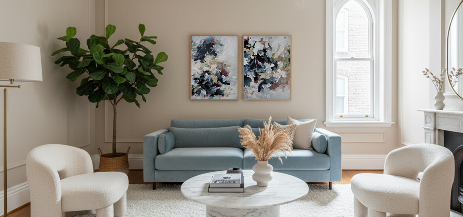 Modern living room with a gray sofa, white chairs, and decorative elements.