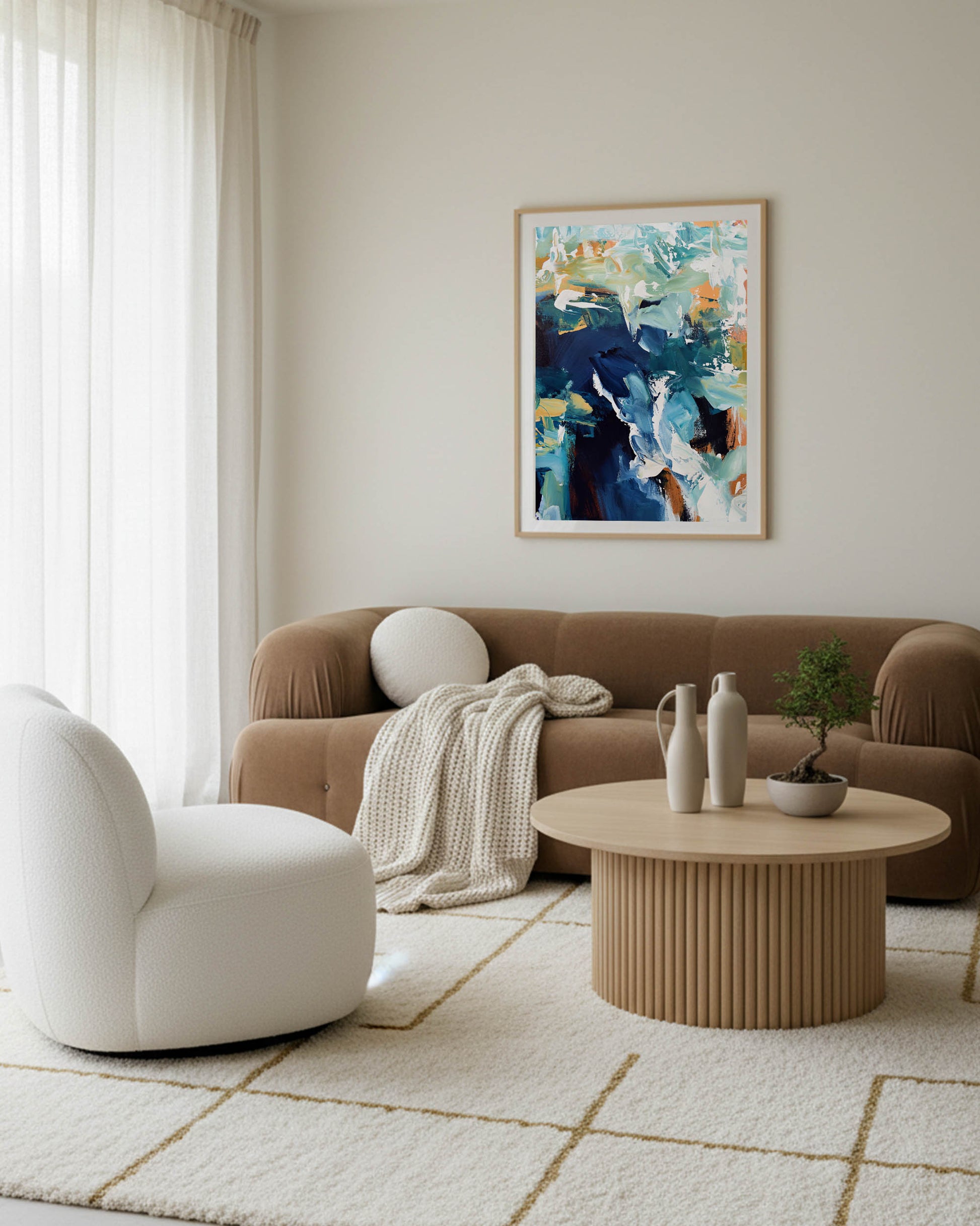 Modern living room with a brown sofa, white armchair, and abstract painting on the wall.