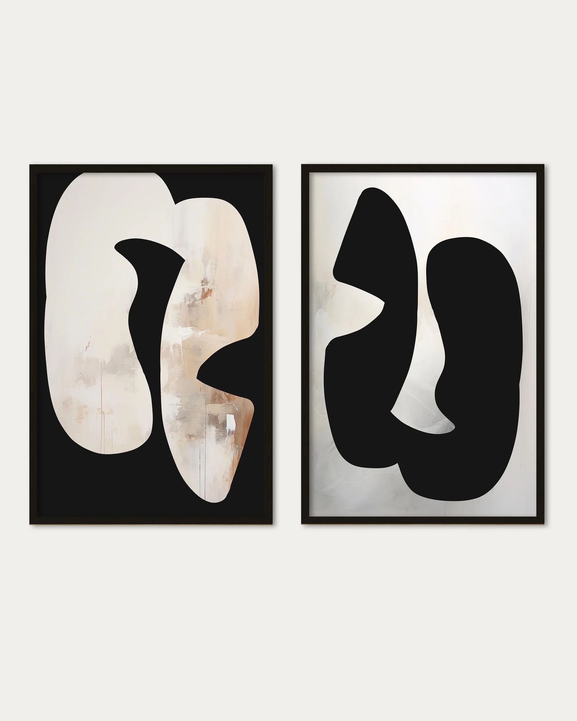 Two abstract art pieces in black and white frames on a light gray background
