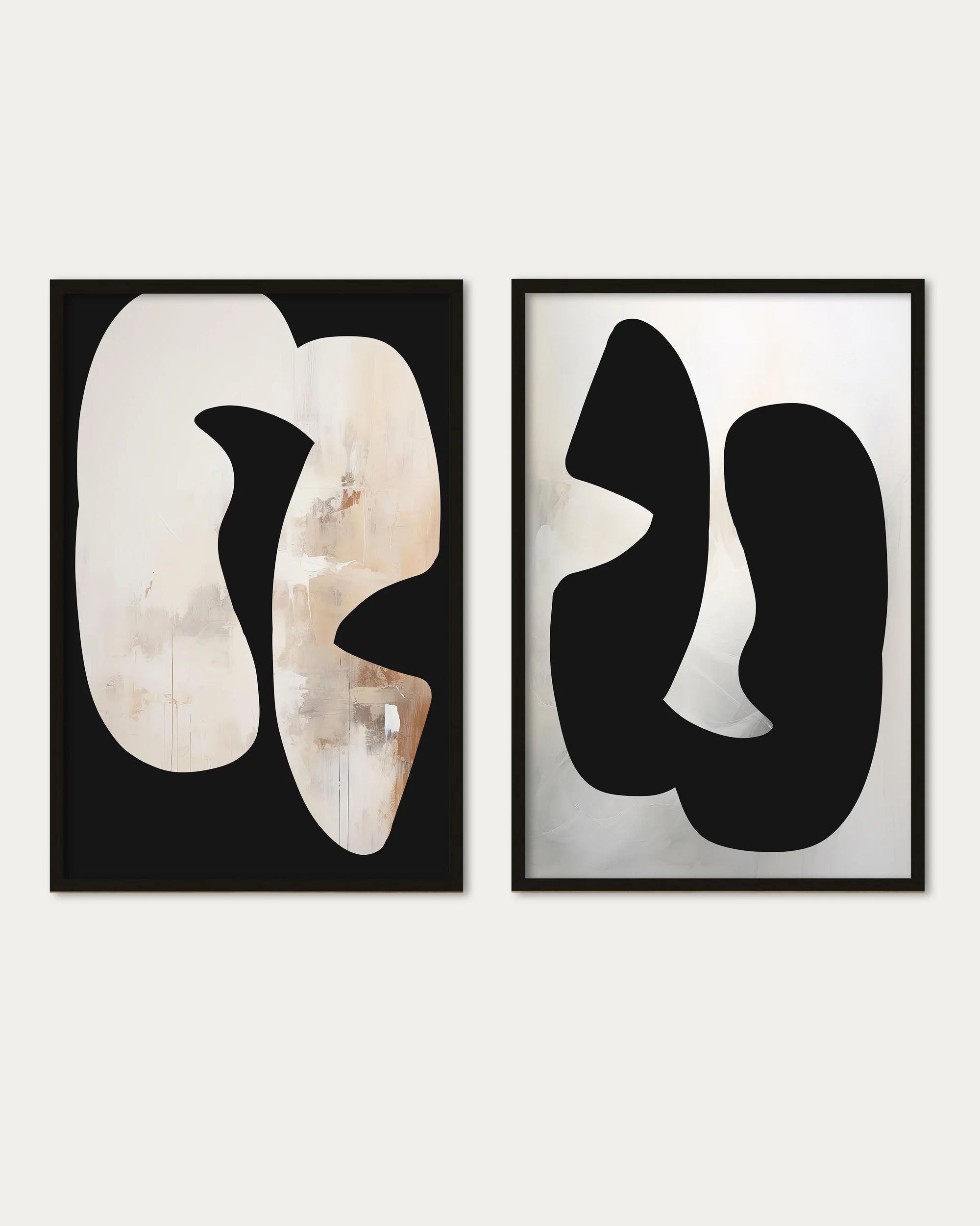 Two abstract art pieces in black and white frames on a light gray background