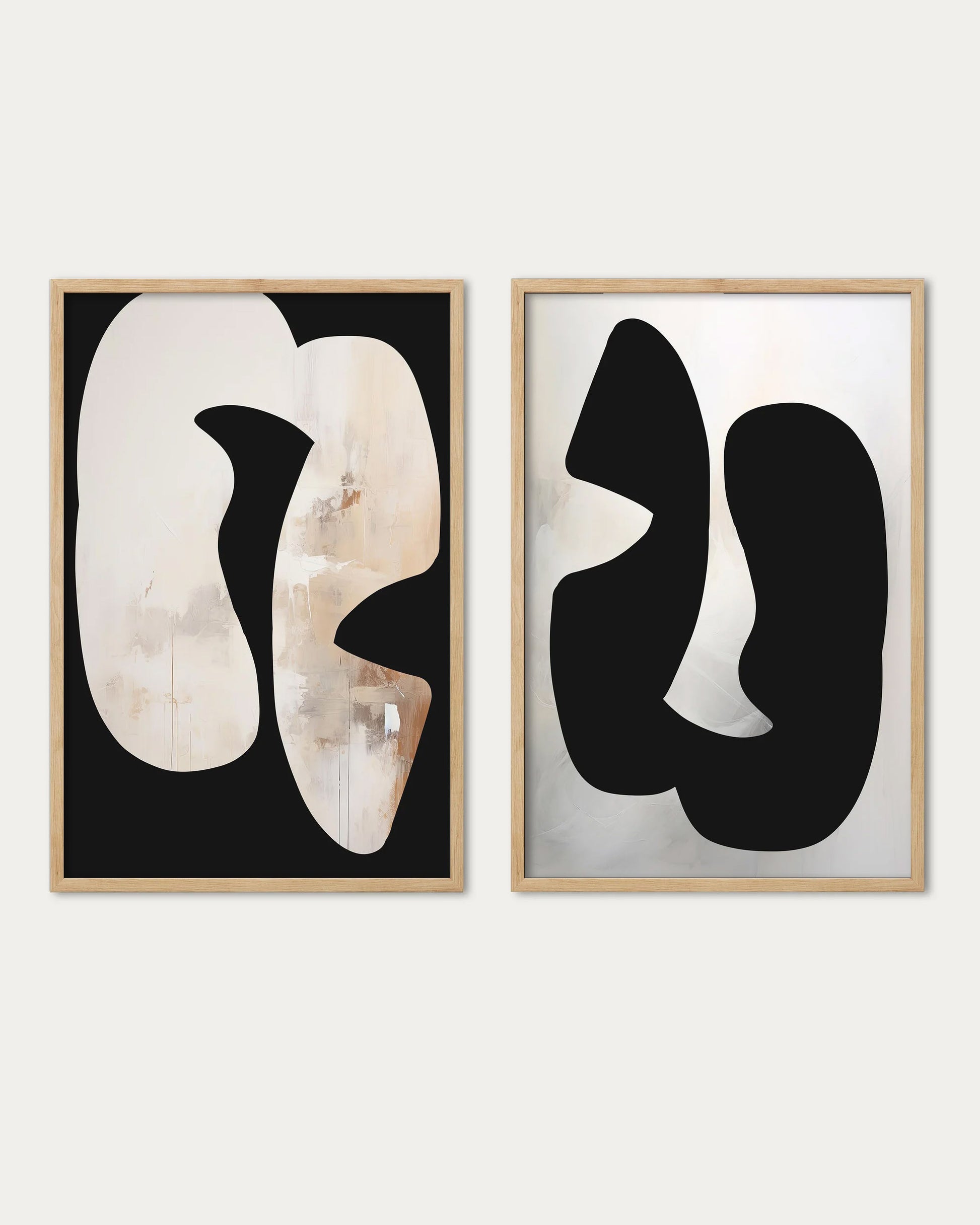 Two abstract art pieces in wooden frames on a white background