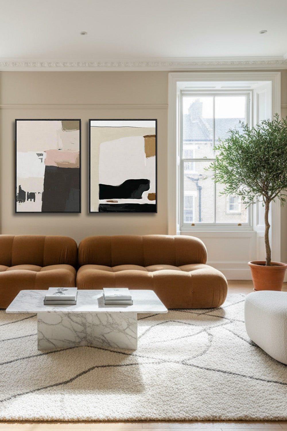 modern living room with brown velvet bubble sofa and two large modern canvas wall art on wall, with large white boucle area rug and olive tree
