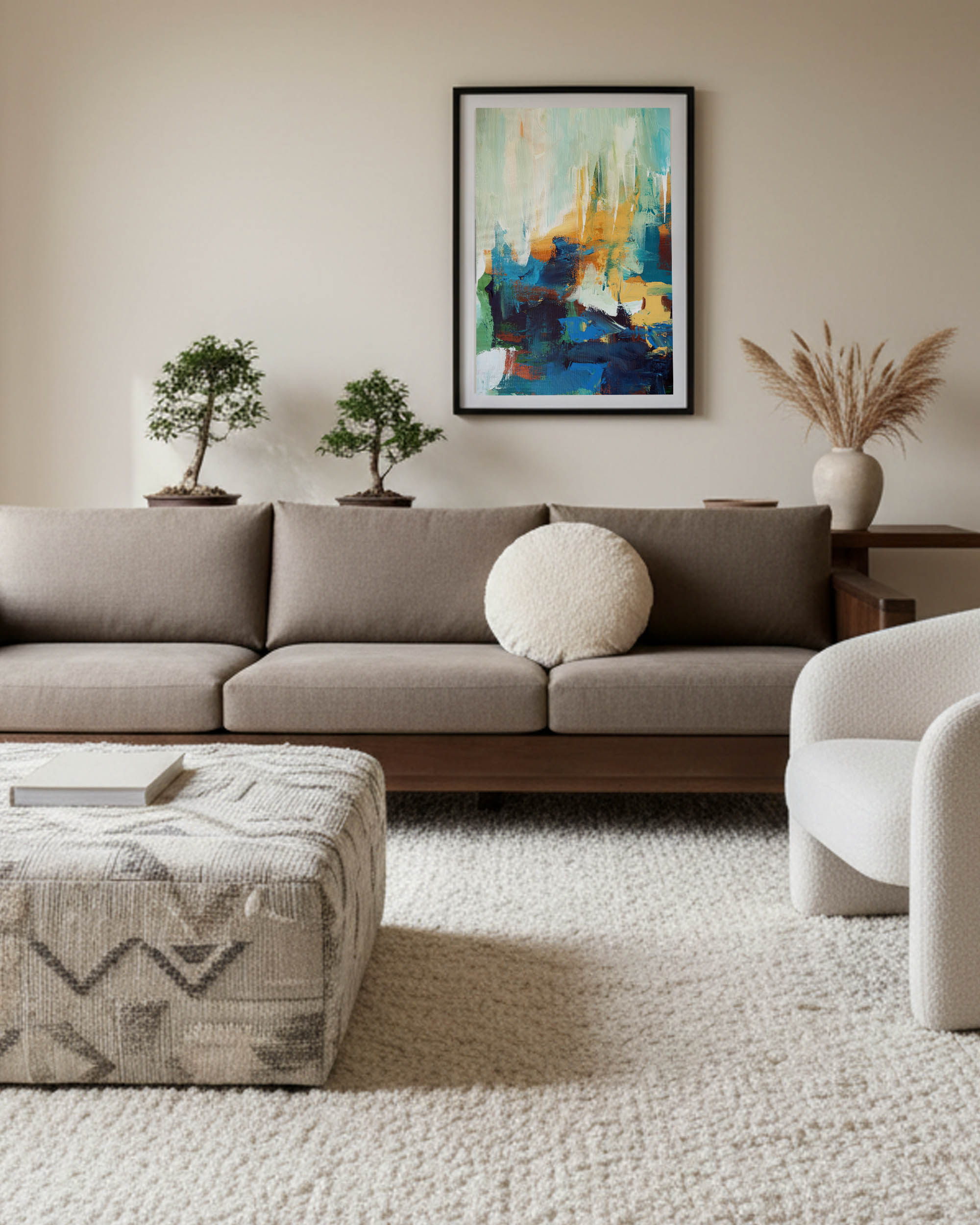 coastal abstract wall art framed in black frame, modern sage and teal art print in japandi muted living room with brown sofa and boucle chair.