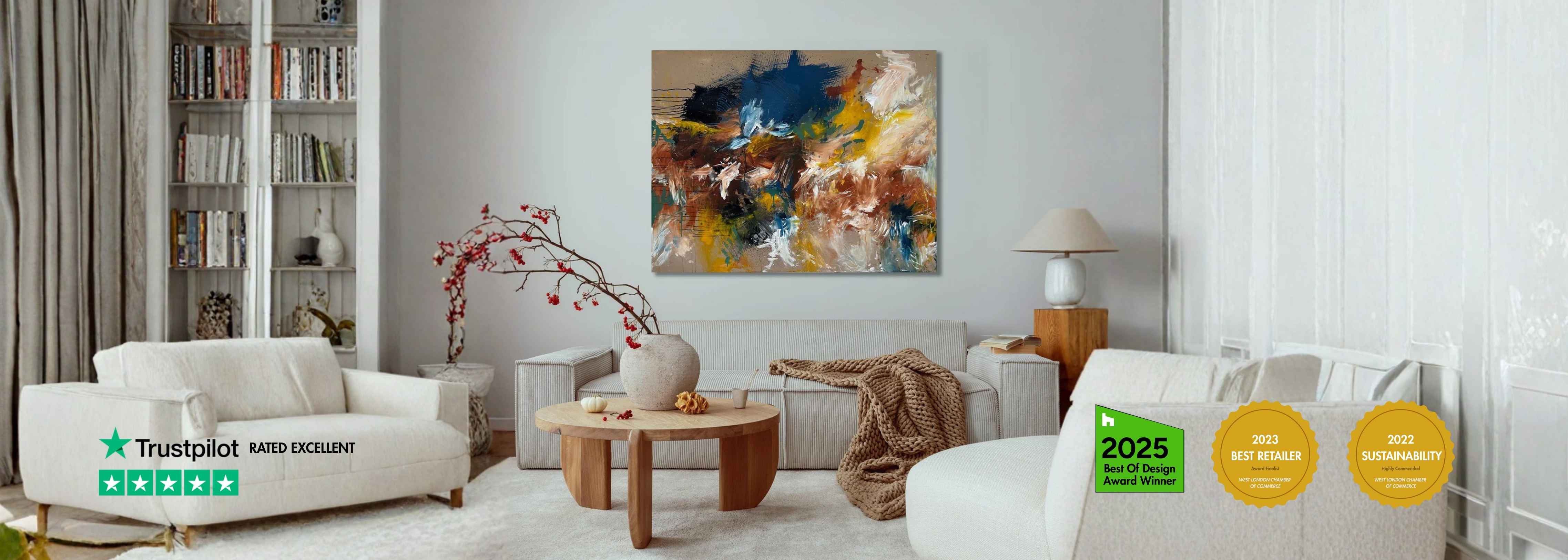 Modern living room with beige designer sofa, natural wood coffee table, and large original abstract painting on a white wall.