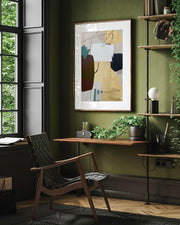 Modern home office with green walls, a wooden chair, and abstract art.